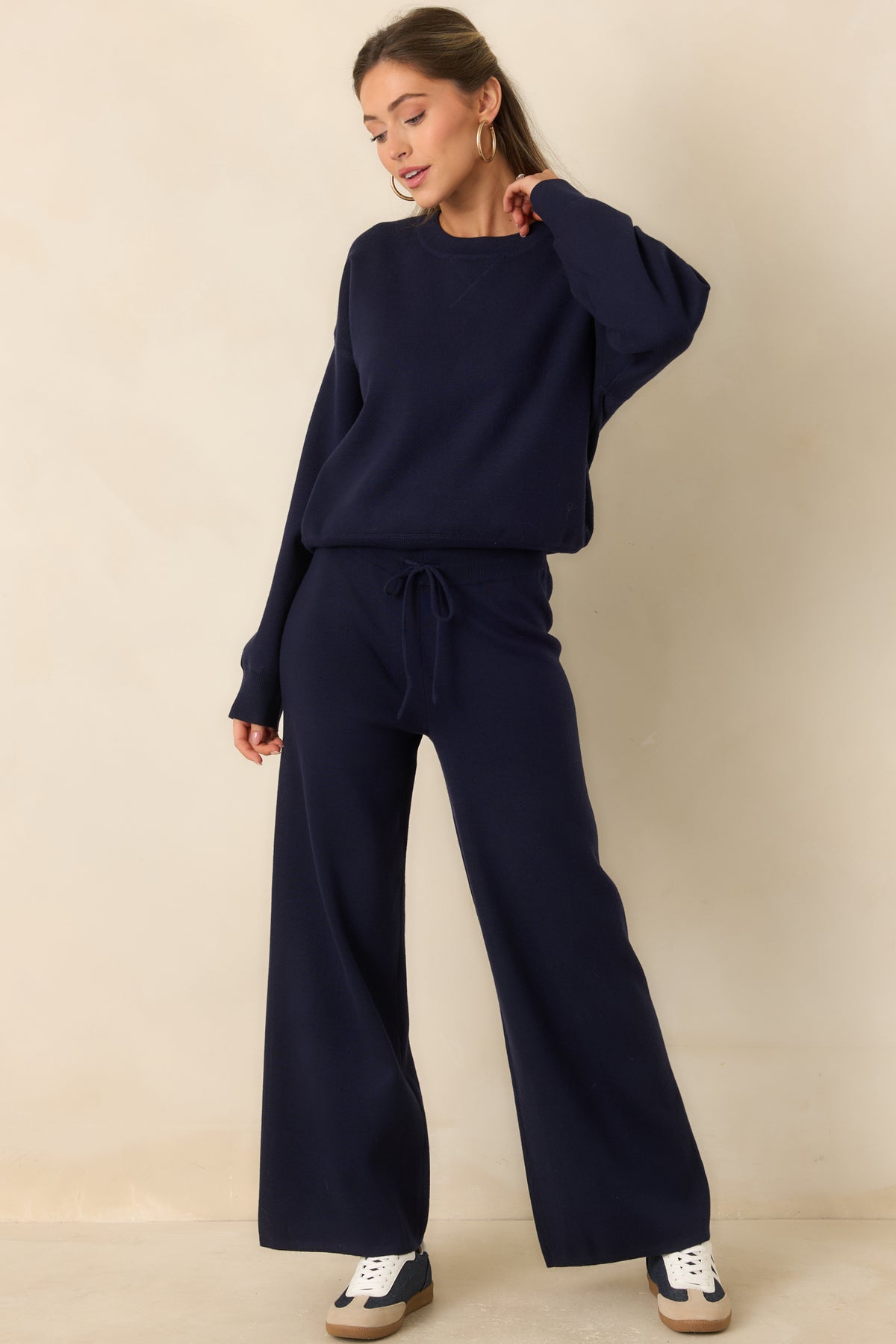 Navy wide-leg pants with a comfortable elastic waist and a fluid drape from hip to hem.