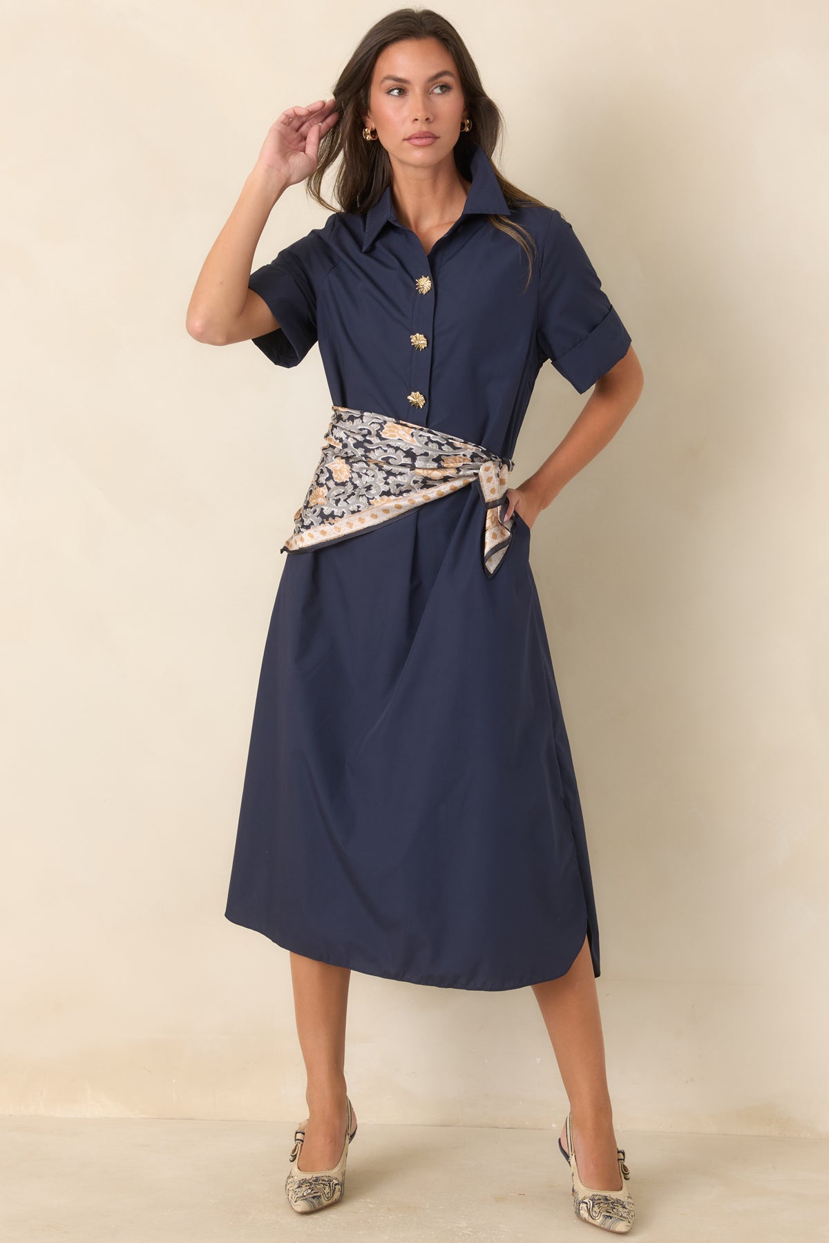 Woven navy maxi dress showcasing statement gold floral buttons, side pockets, and a comfortable relaxed silhouette.