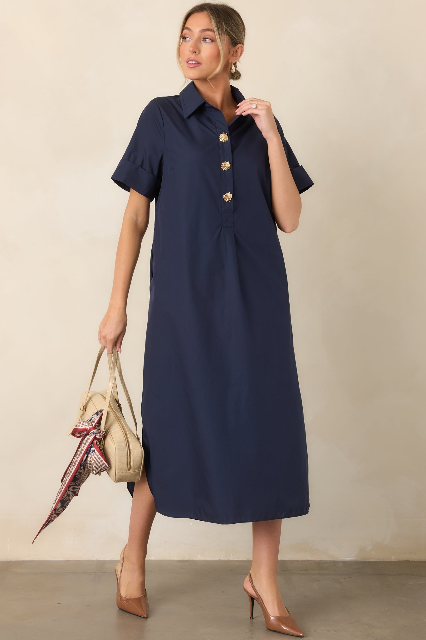 Woven navy maxi dress highlighting its collared neckline, short rolled sleeves, and elegant floor-length design with side slits.