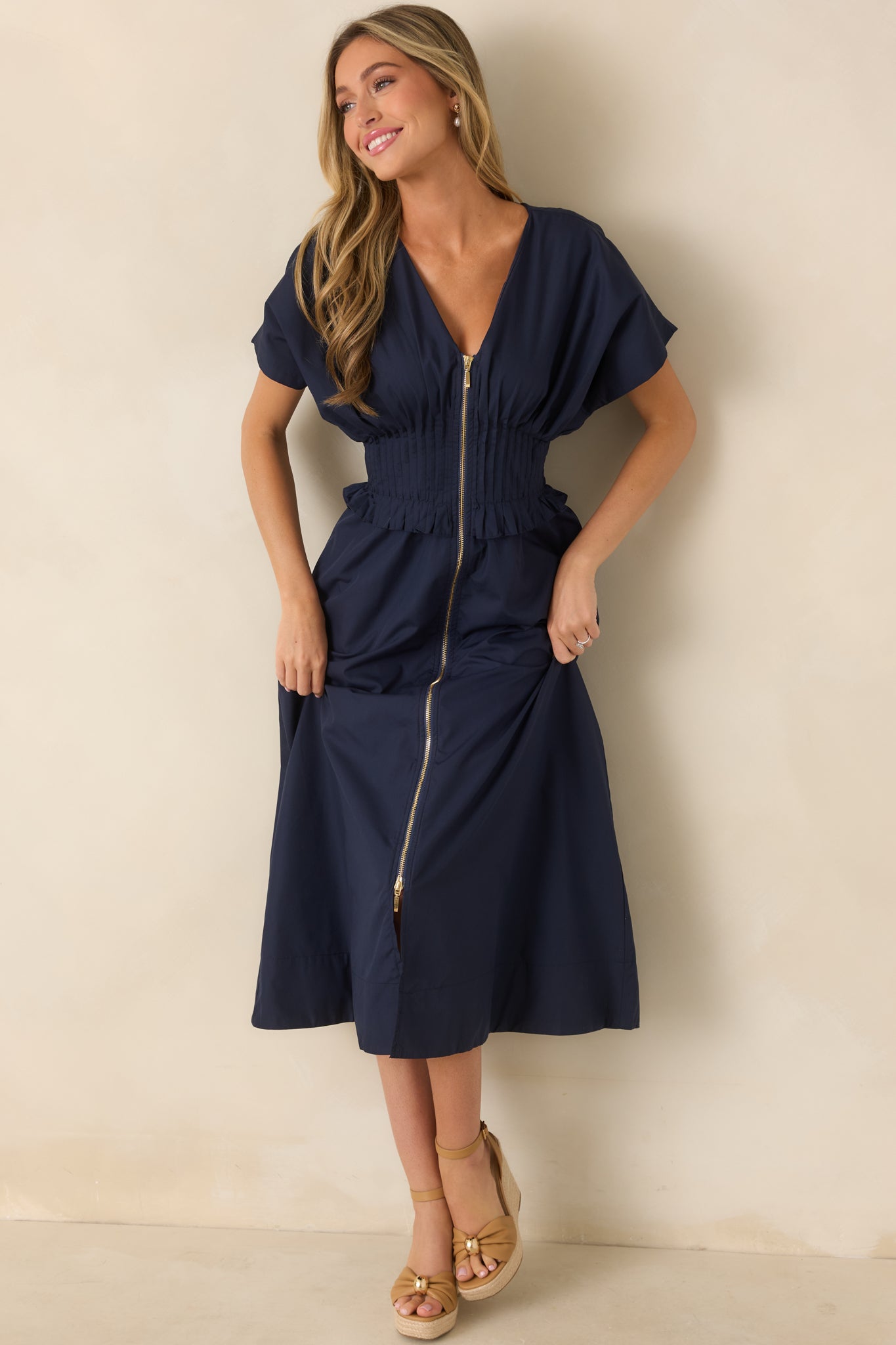 Navy woven maxi dress featuring a V-neckline, front zip closure, short sleeves, and A-line skirt.