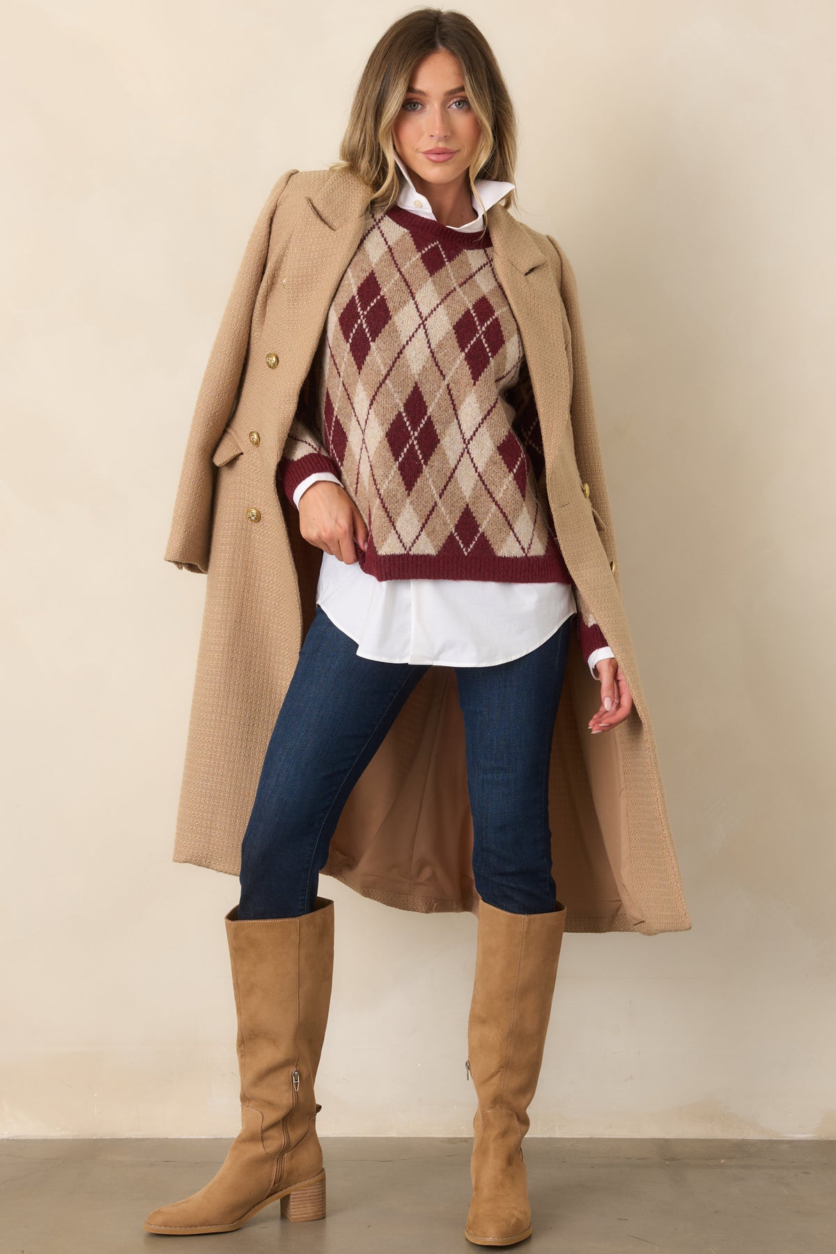 Coordinating neutral argyle diamonds cover this relaxed sweater, finished with long sleeves and ribbed edges.