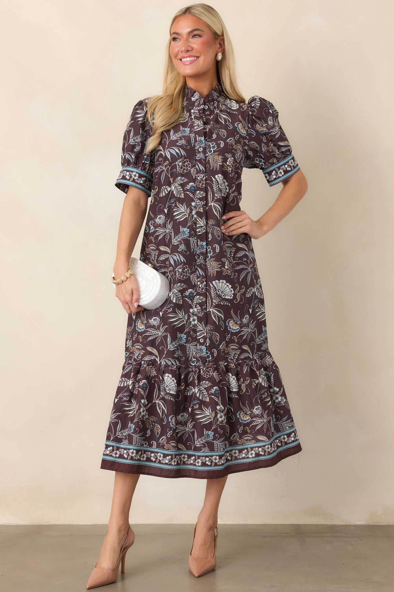 Relaxed midi dress showcasing an intricate floral pattern, classic collar, functional front buttons, and convenient side pockets.