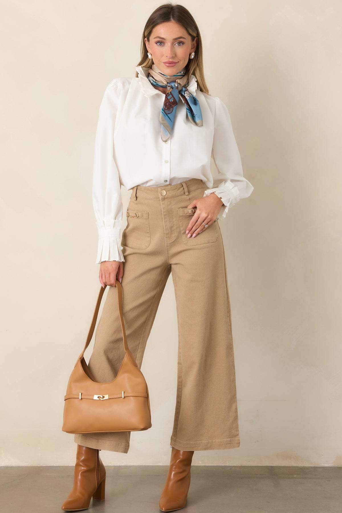 Neutral high-rise pants with a wide-leg silhouette, oversized front patch pockets, and gold-tone horsebit hardware.