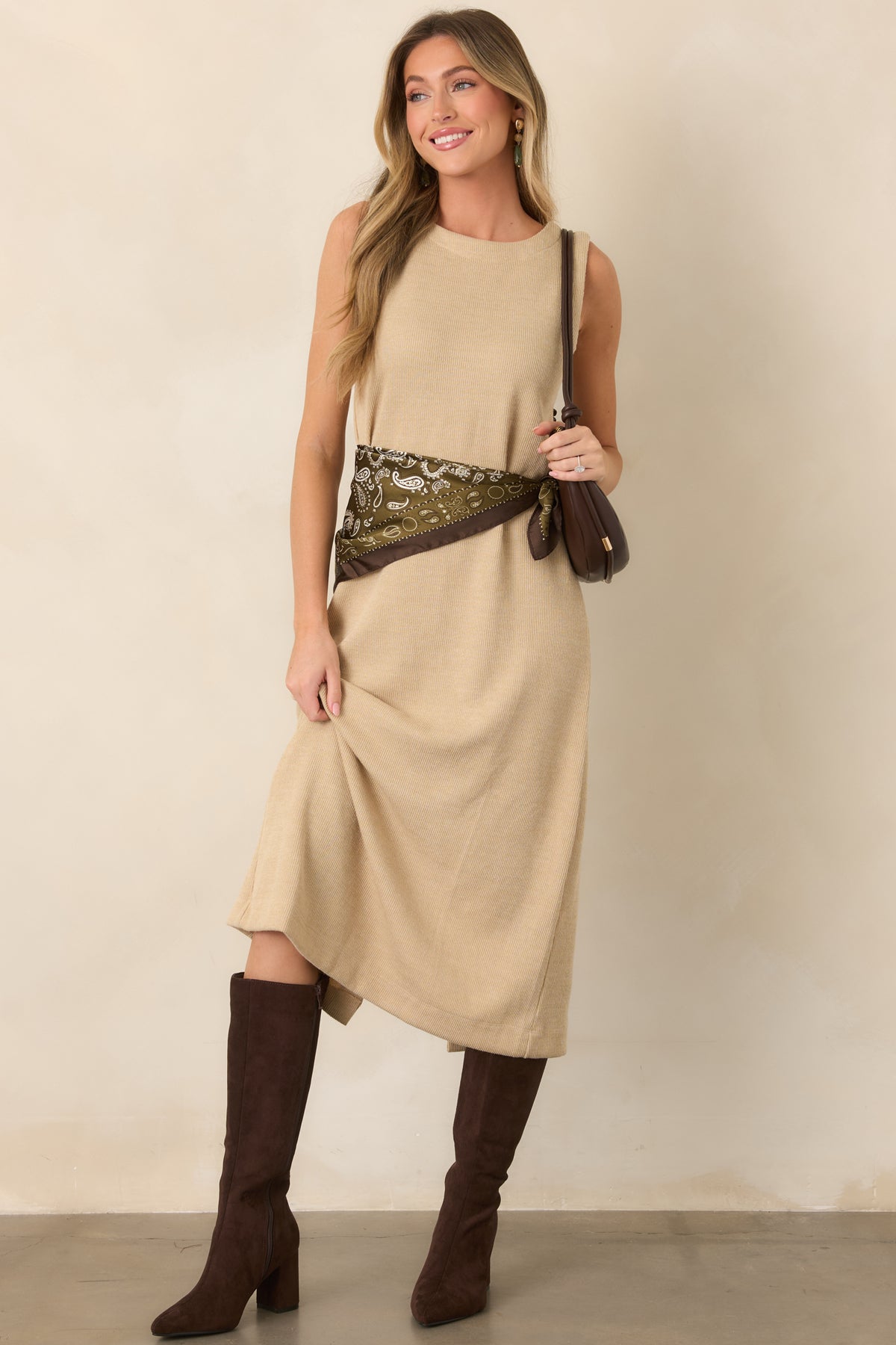 Neutral natural knit midi dress featuring a softly fitted silhouette, sleeveless construction, and understated ribbed texture throughout.