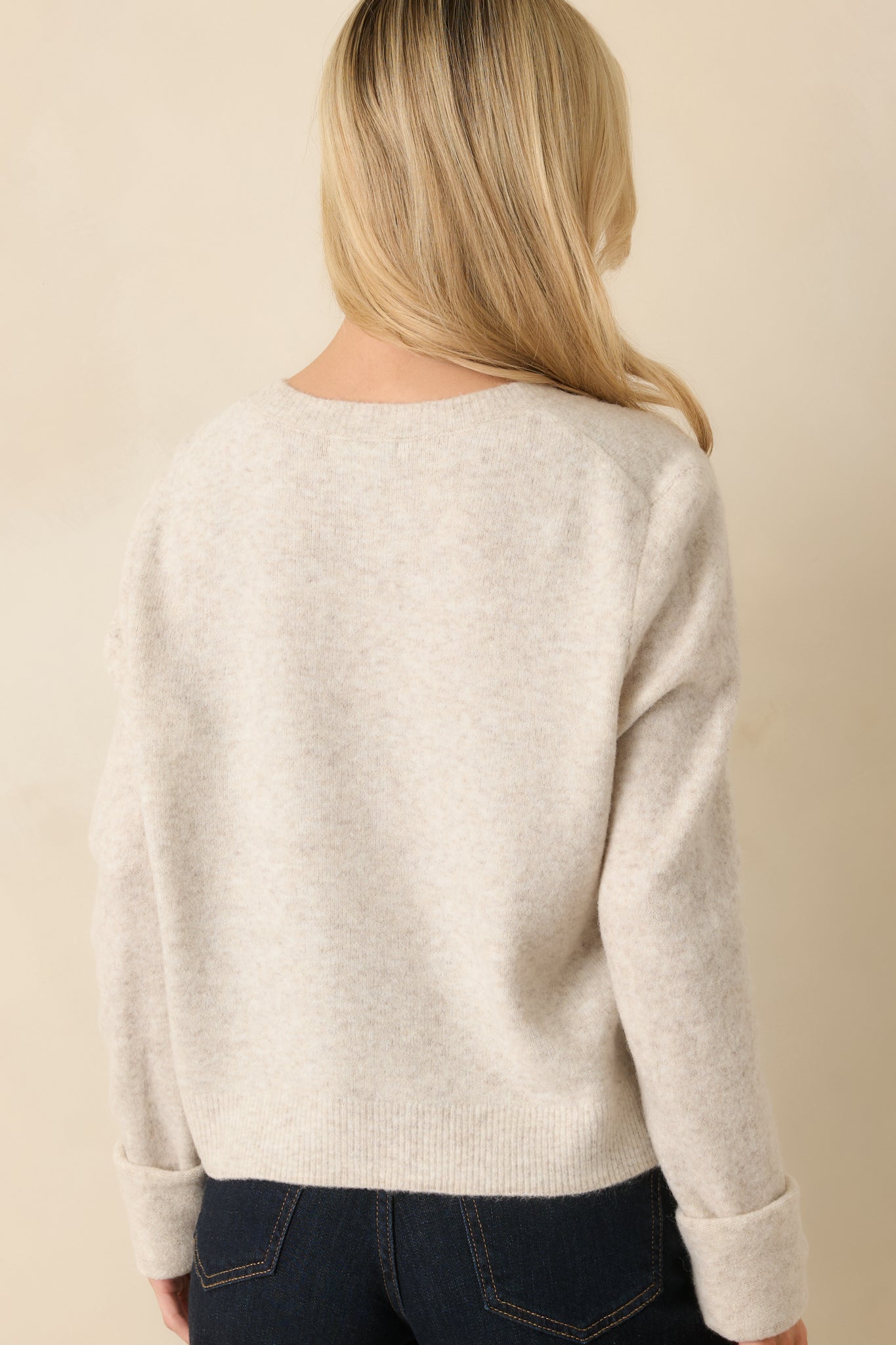 Rear view of the oatmeal cardigan showing relaxed fit and clean knit finish.