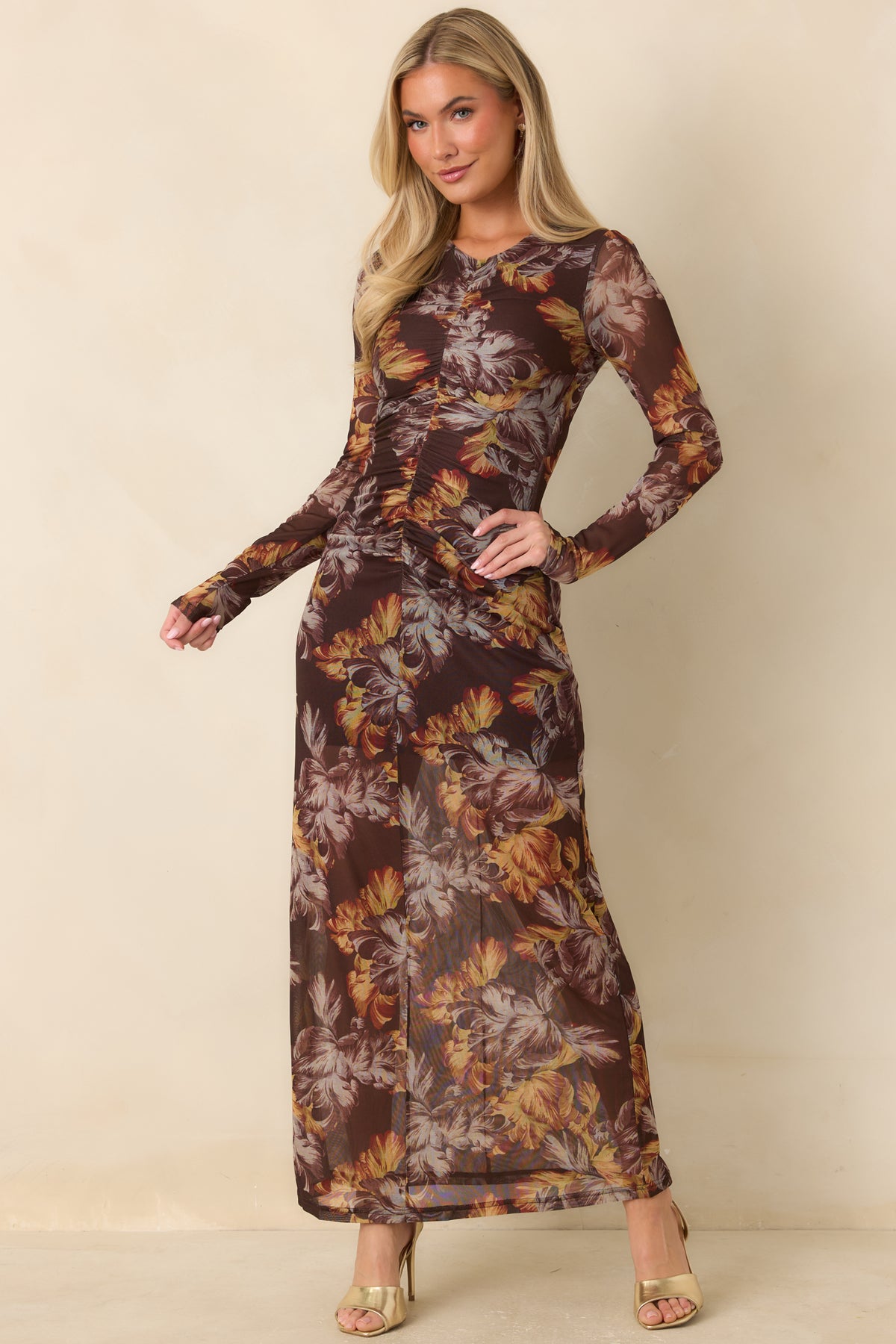 Brown fitted dress patterned with golden ochre, rust, and taupe florals from neckline to hem.