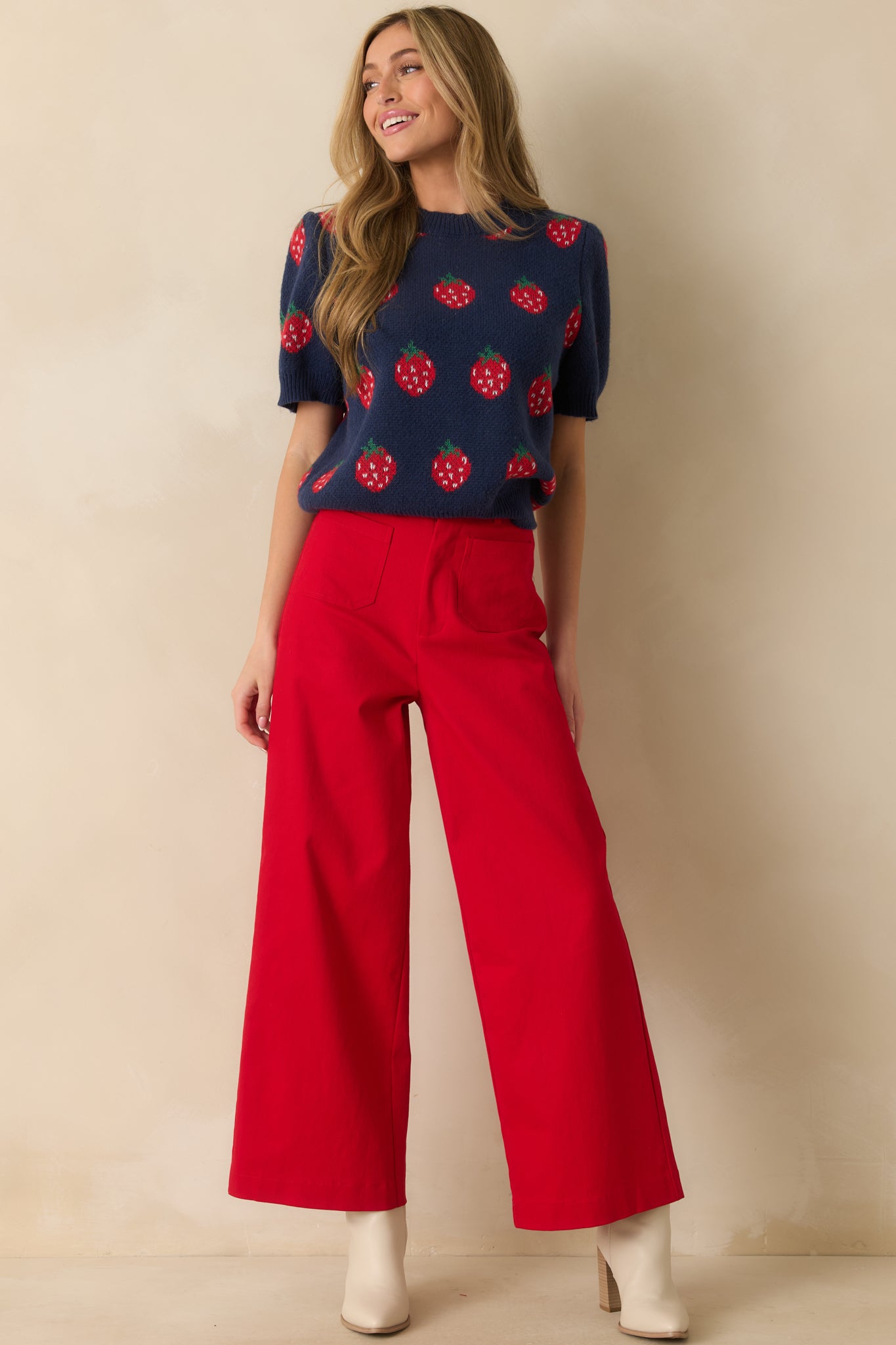 Front view of polished red denim jeans featuring belt loops, button-zip fly, and relaxed wide-leg fit.