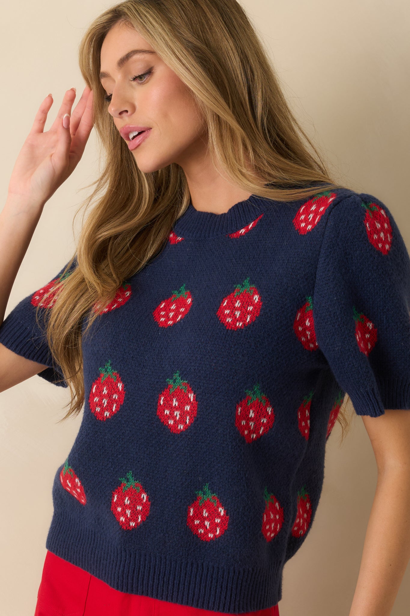 Detailed view of midweight knit showing red strawberry design and relaxed fit.