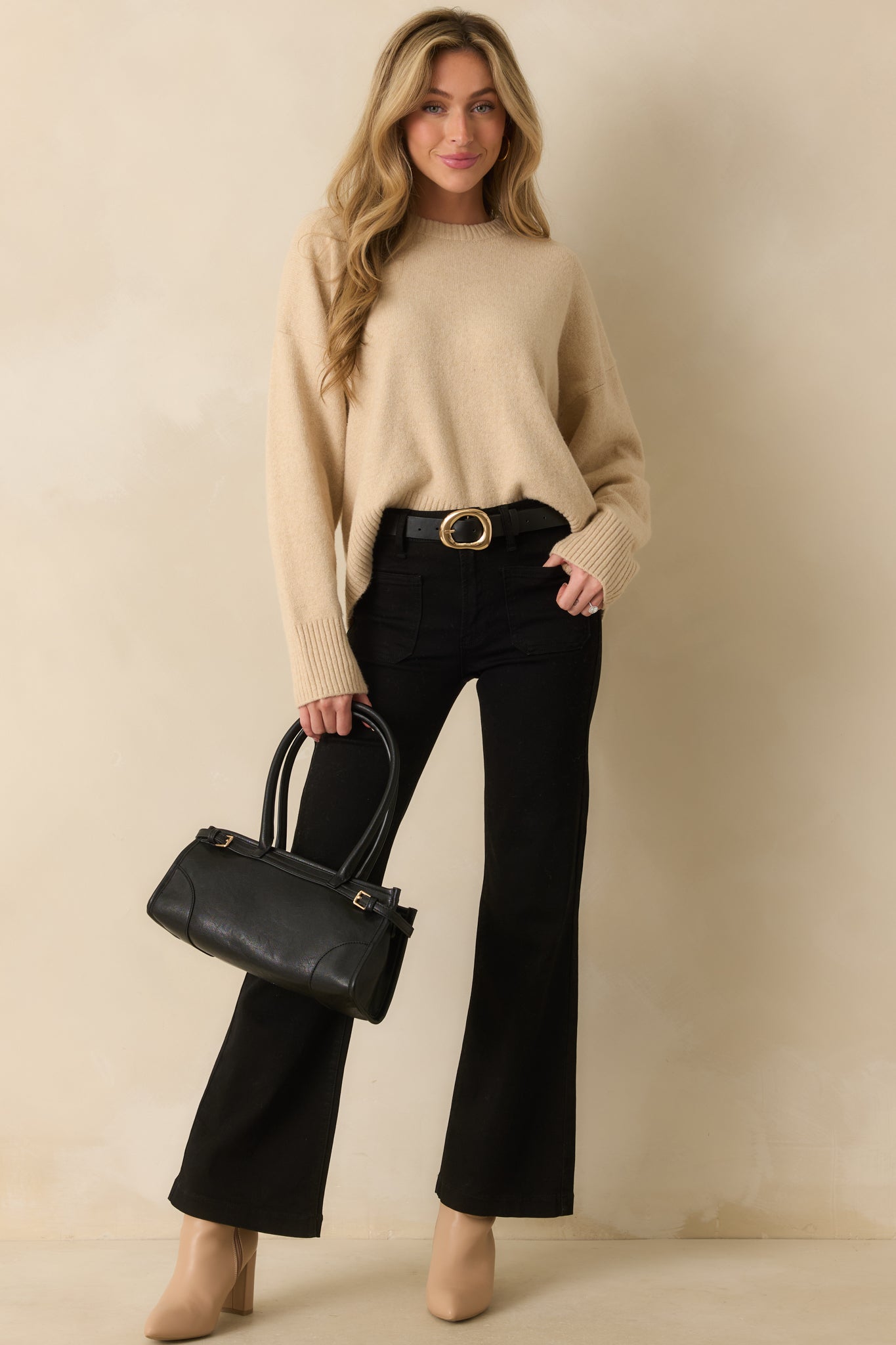 Full body front view showing the brushed knit texture and relaxed fit of the beige sweater.