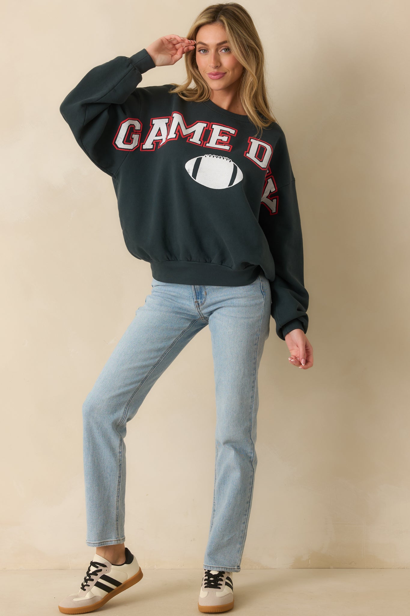 Casual crewneck sweatshirt in faded black with ribbed trim and a sporty game-day graphic.