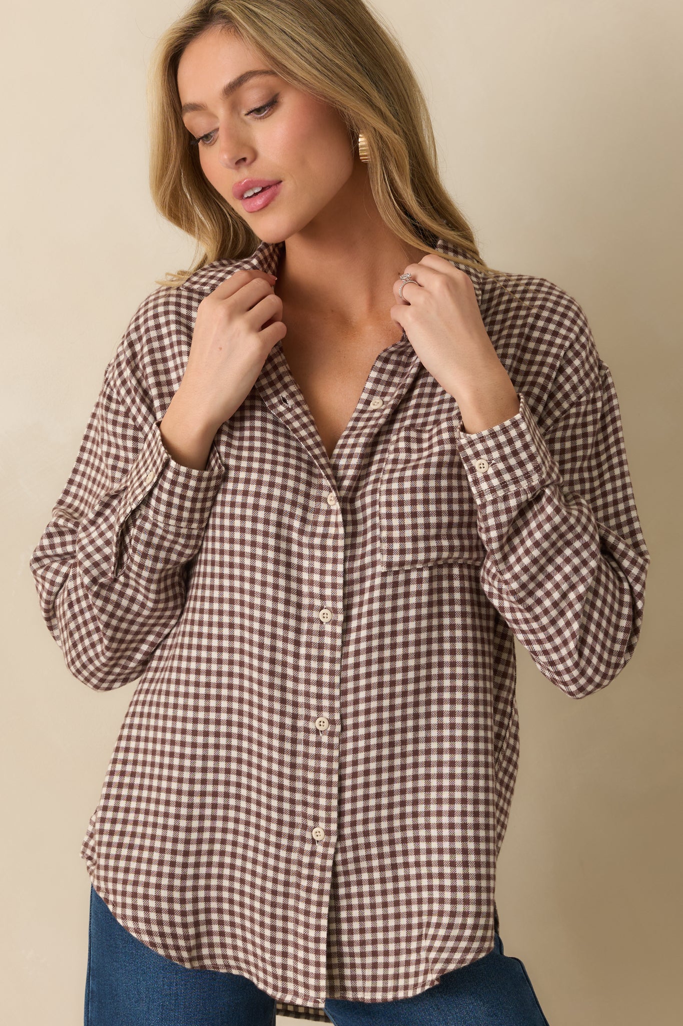 Cropped front view showing the button-up placket and long sleeve cuff details.