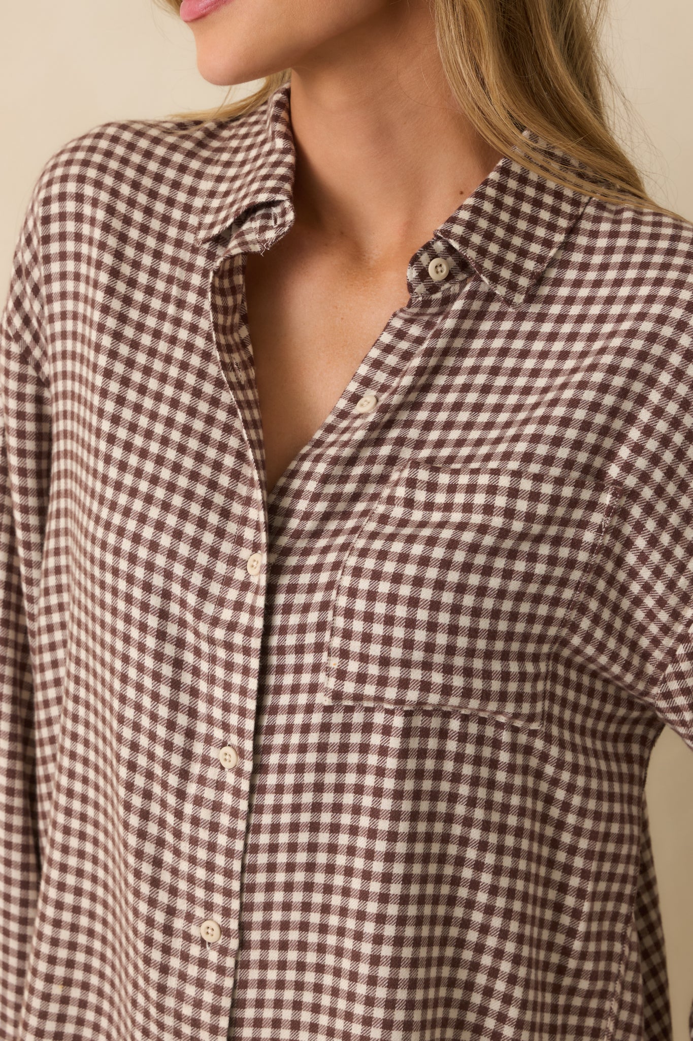 Close-up detail shot of the gingham pattern, collar, and button detailing.