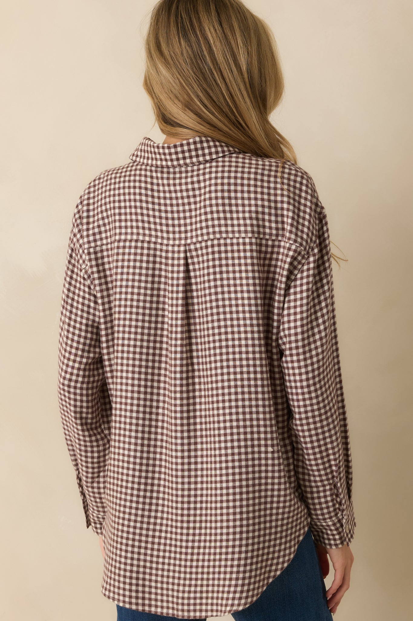 Back view of the top showing the relaxed fit, long sleeves, and continuous gingham print.