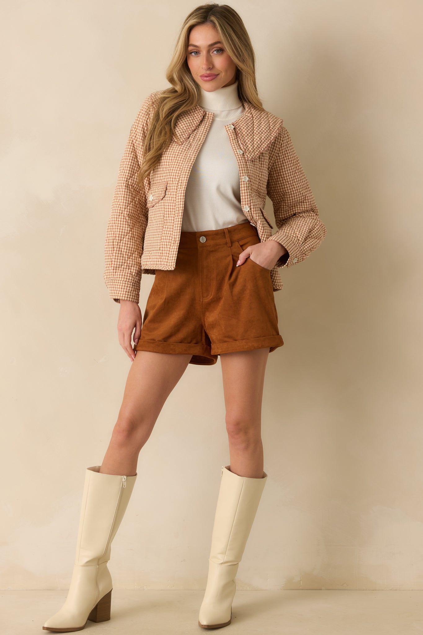 Full body close-up front view highlighting ivory flower buttons and the overall quilted diamond pattern on the jacket.