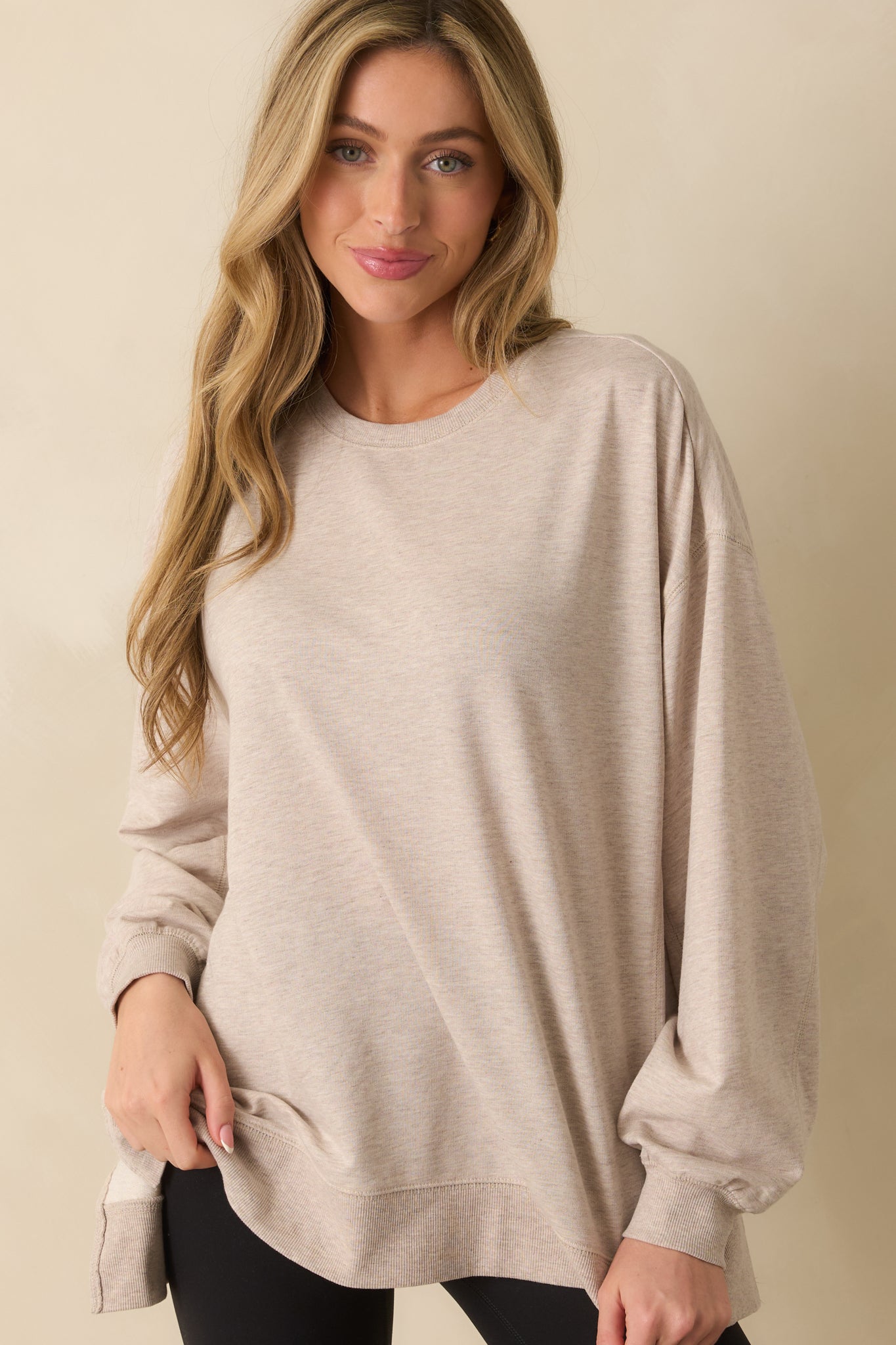 Detail of the lower front panel, highlighting the sweatshirt’s fabric texture and relaxed fit.