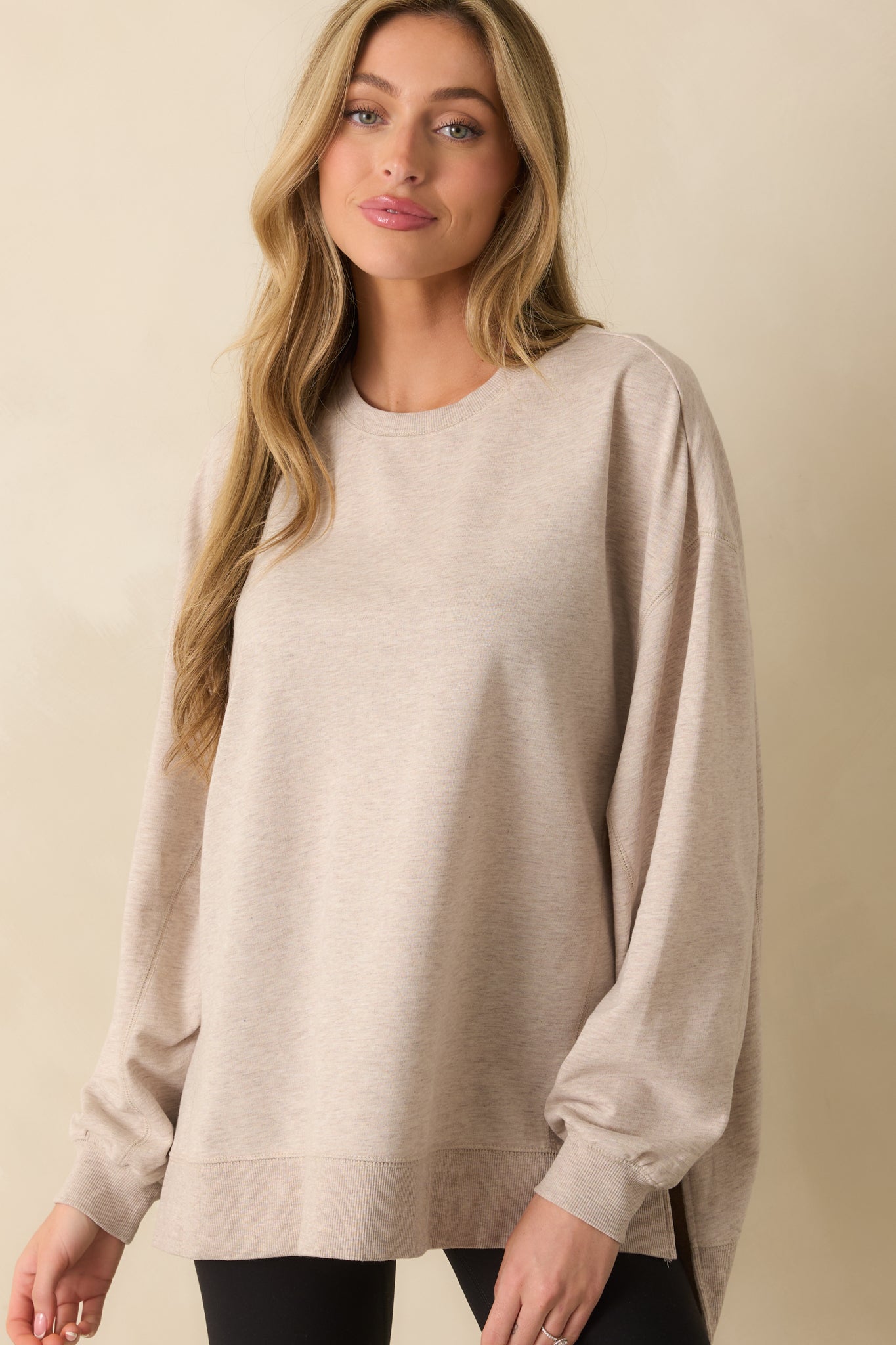 Cropped view of the midsection, emphasizing the high-low hem and side slit design.