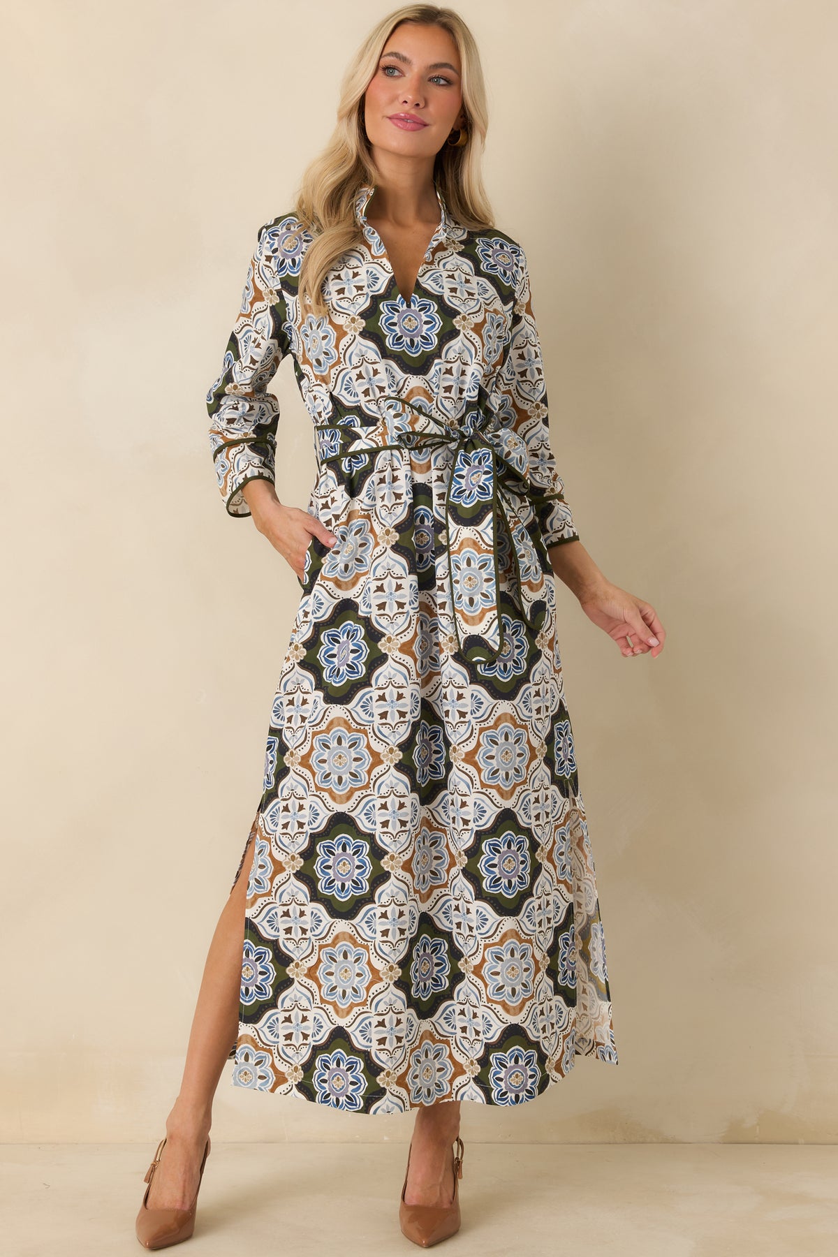 Olive, blue, ivory, camel, and brown medallion maxi dress with a stand collar, tie waist, three-quarter sleeves, and pockets.
