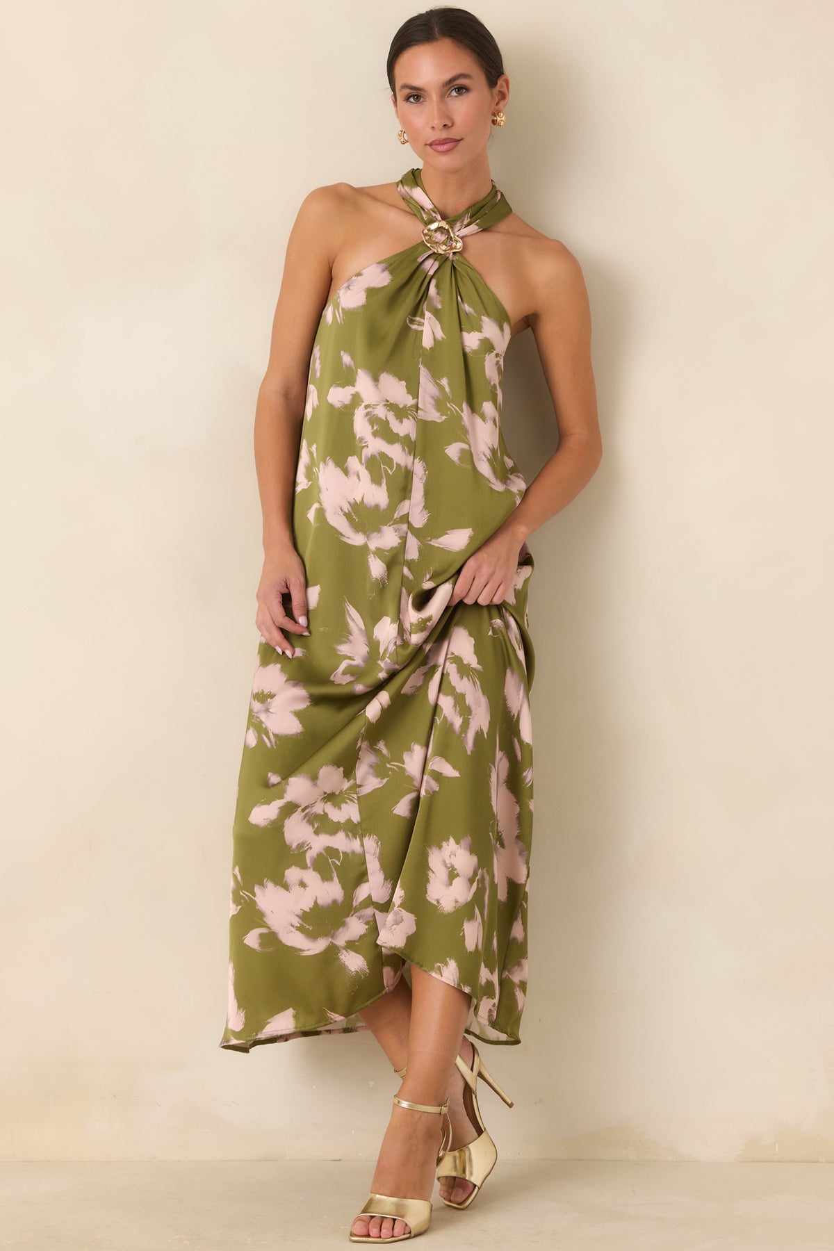 Flowing olive dress featuring blush floral artwork, a jewelry-inspired gold-tone neckline accent, and gently widening maxi hem.