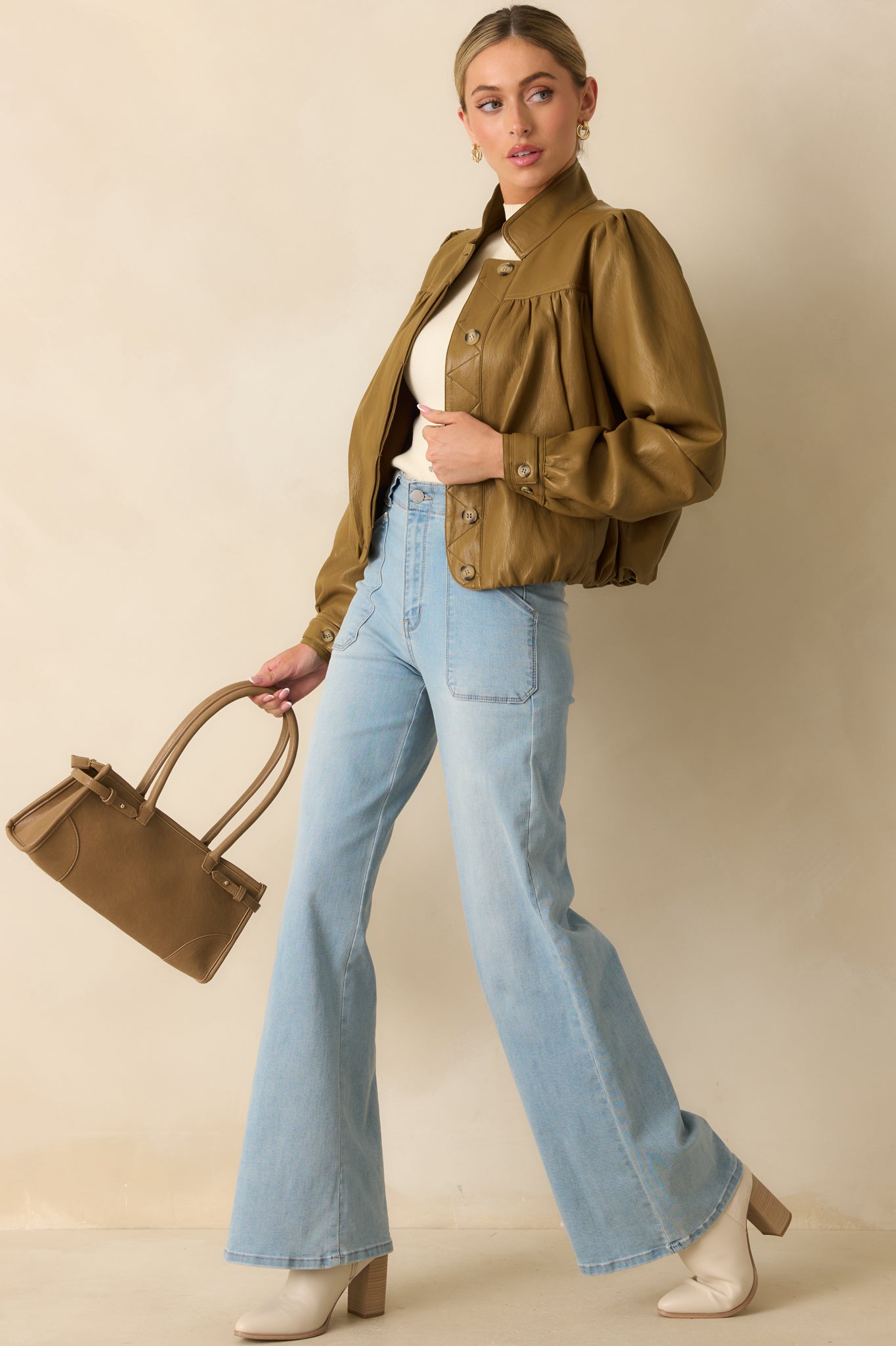 Olive brown faux leather jacket paired in a full look emphasizing its structured cut and timeless retro vibe.