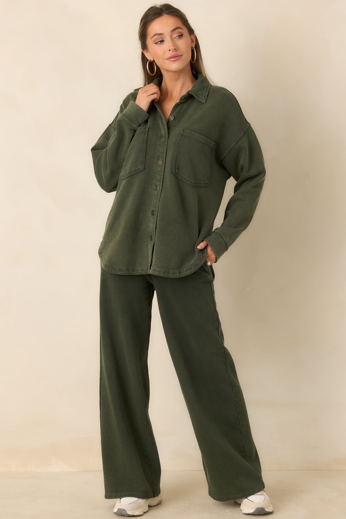 Relaxed olive utility jacket featuring dropped shoulders, long sleeves, and a curved hem.