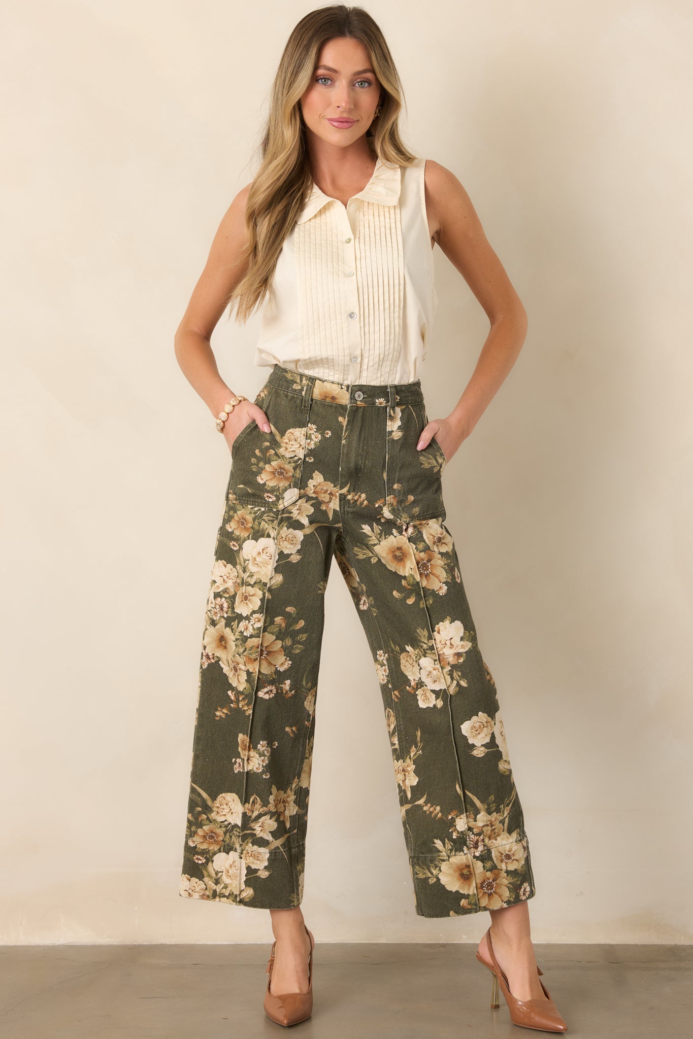 Printed cotton pants with a polished wide-leg shape, high-rise fit, and contrasting ivory floral motifs throughout the olive green fabric.