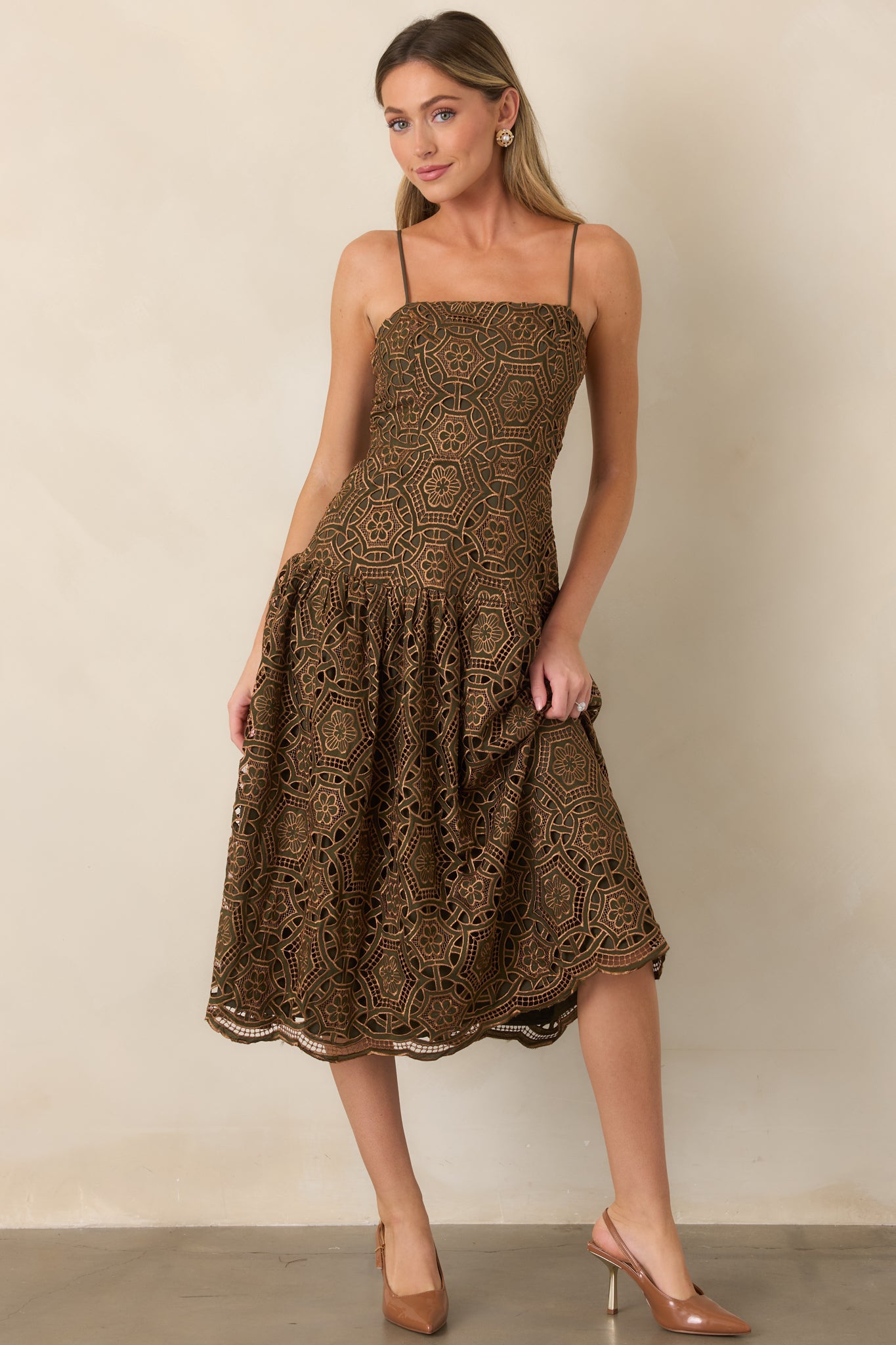 Olive and gold midi dress with a fitted bodice, shaped waist, and gathered skirt that creates graceful movement.