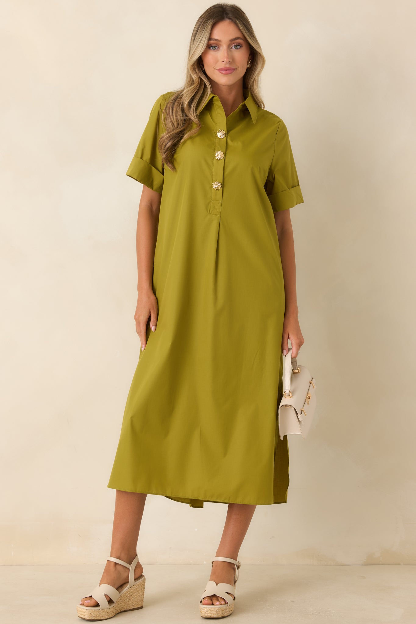 Olive green button-front maxi dress with short sleeves, practical side pockets, and a timeless everyday style.