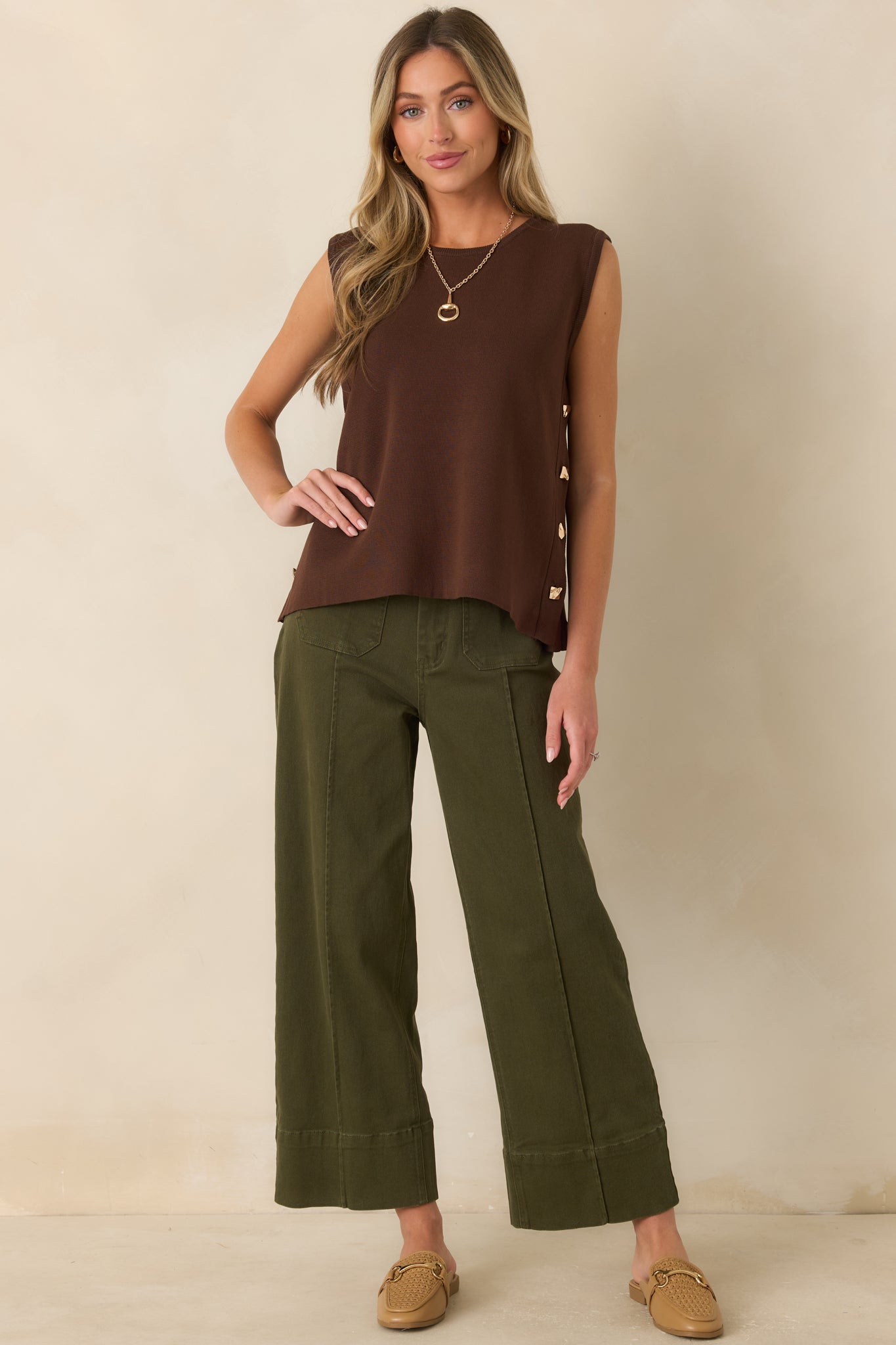 Olive green cropped wide-leg pants featuring a high-rise waist, oversized front patch pockets, and wide cuff hems.