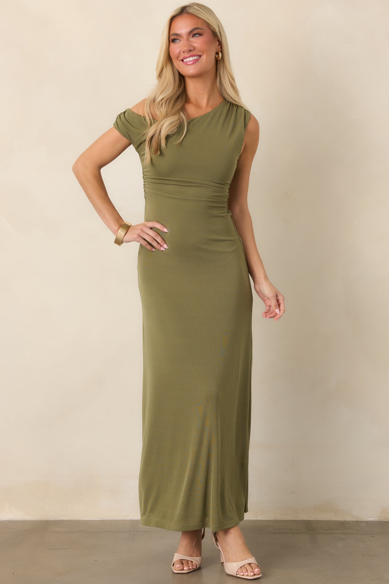 Rich olive green dress designed with flattering waist ruching, a fitted shape, and graceful fluid skirt.