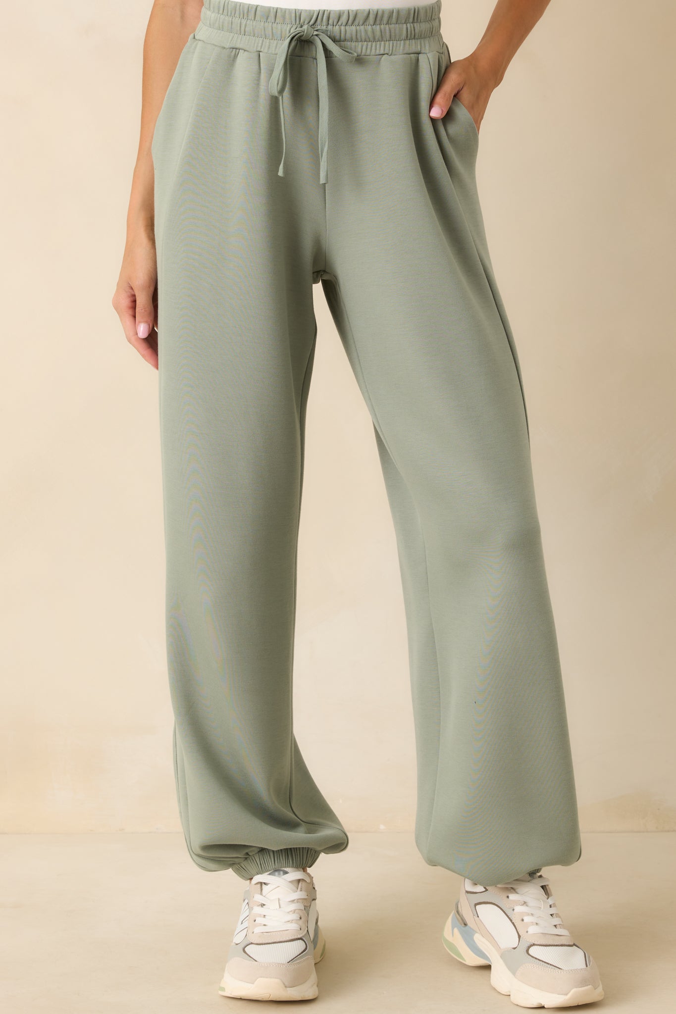 Cropped view of the waistband area showing the gathered elastic and drawstring tied at center front.