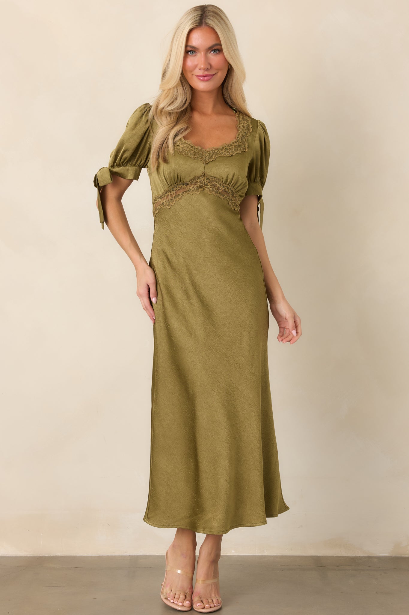 Lustrous midi dress combining a lace-trimmed bodice, gathered puff sleeves with self-tie cuffs, and a fluid satin skirt.