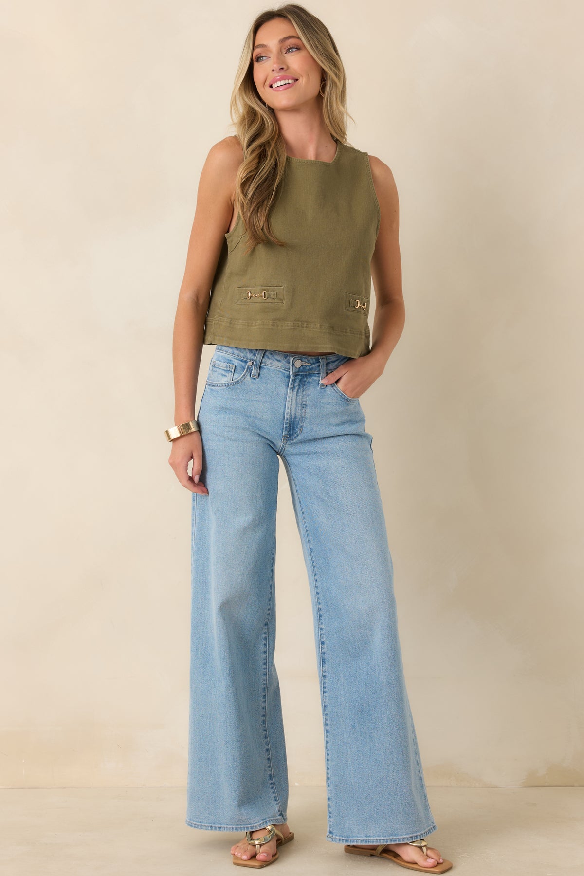 Olive green sleeveless denim top featuring a relaxed A-line shape, cropped length, and refined gold hardware.