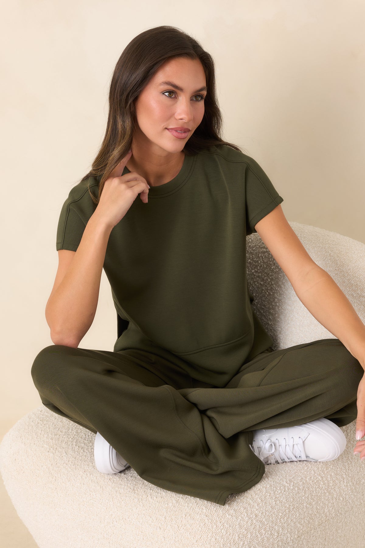 Olive-green spacer fabric top featuring a smooth lightweight feel, short sleeves, and side slits.