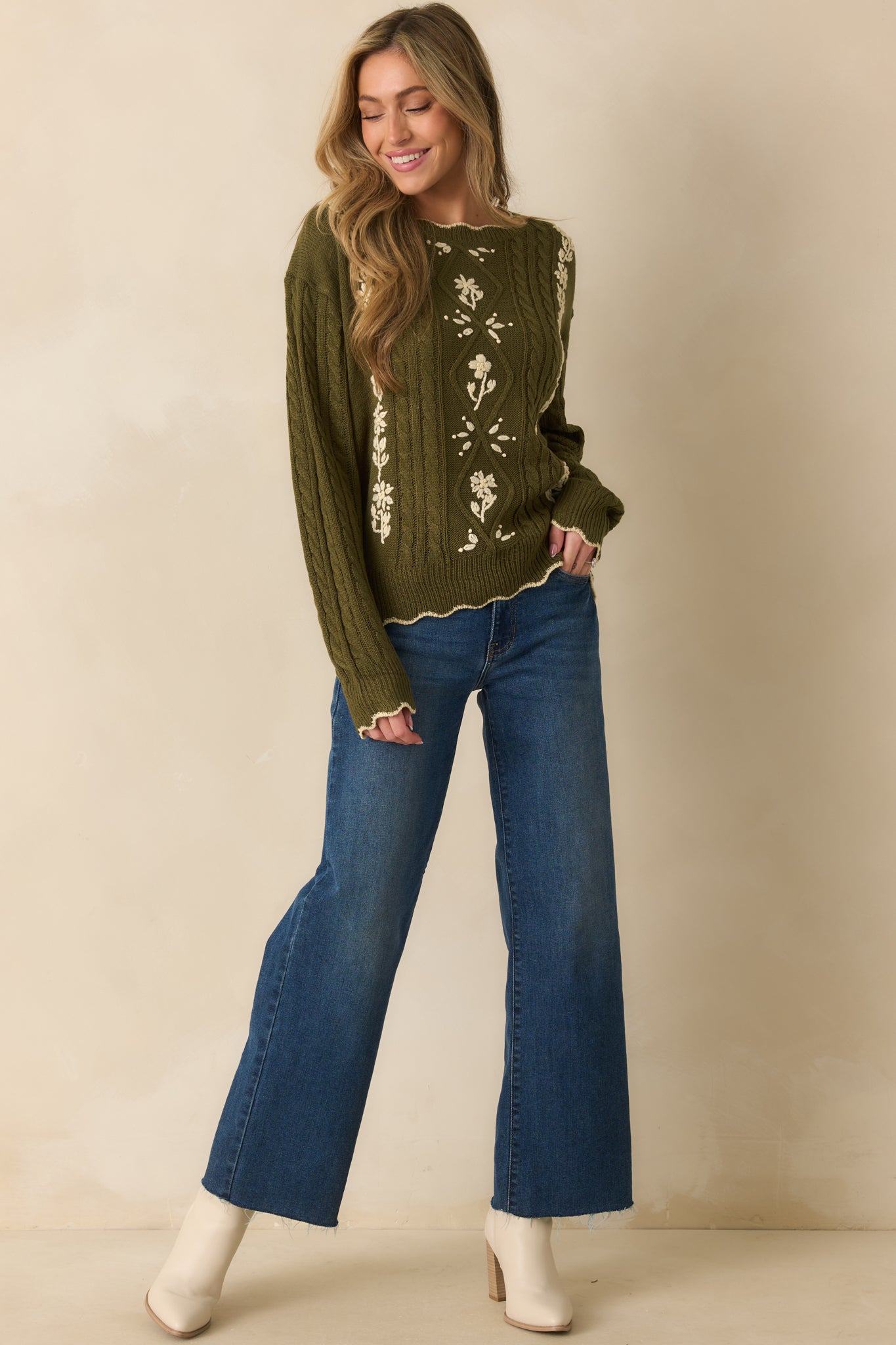 Olive green sweater featuring an embroidered floral design and ribbed cuffs for a polished finish.
