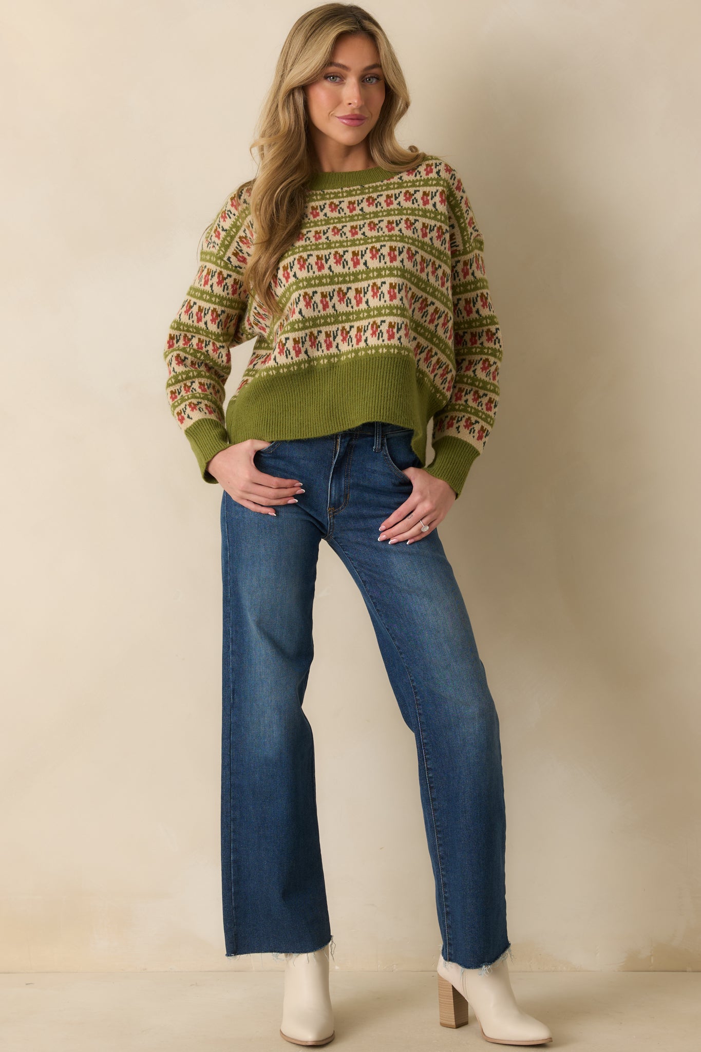 Patterned olive green sweater featuring long sleeves and multicolor Fair Isle design in earthy tones.