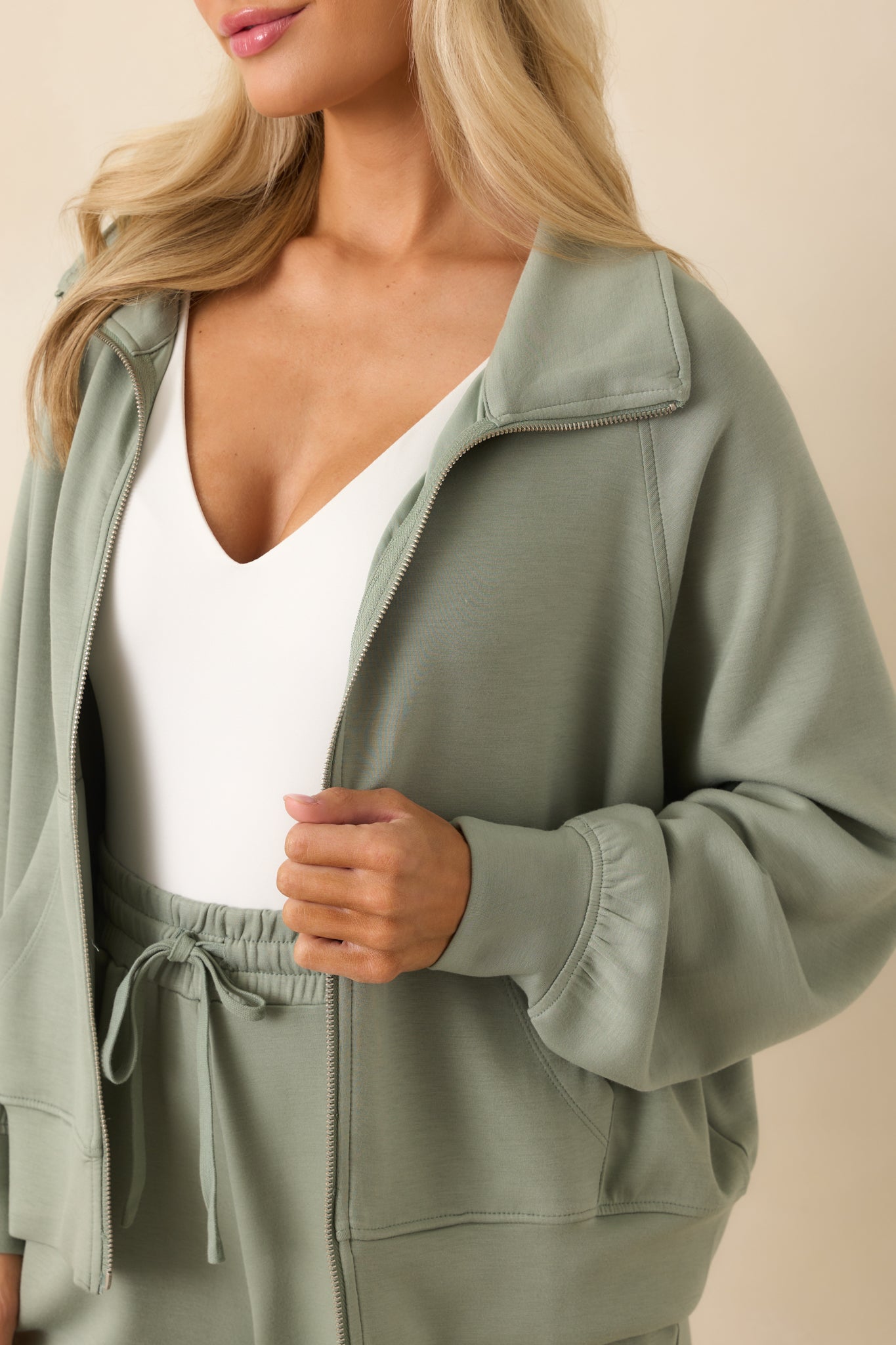 A close-up of the zip front and stitching details around the front panel and collar.