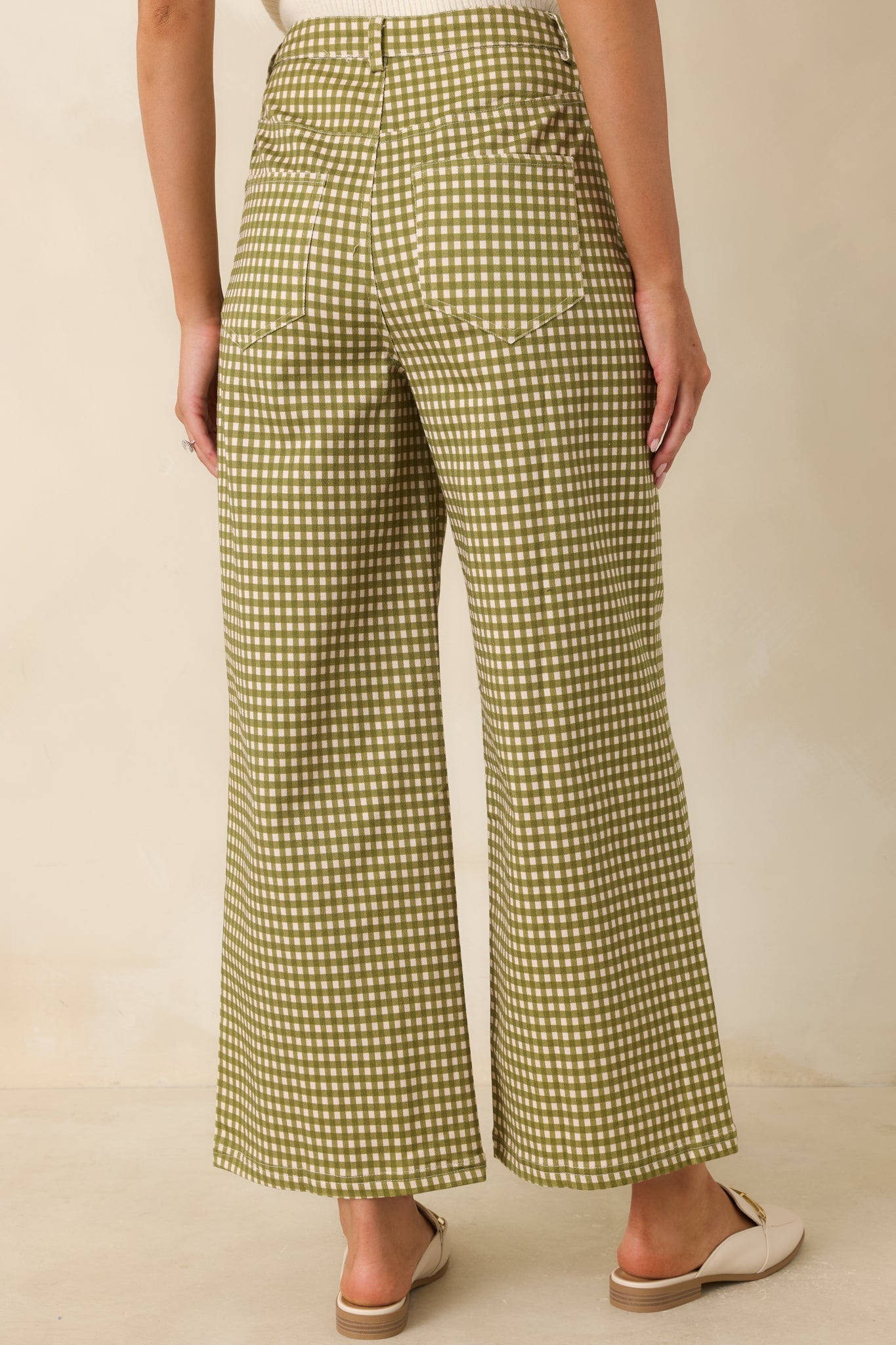 Rear view of the olive and ivory gingham pants featuring back pockets and a relaxed wide leg silhouette.