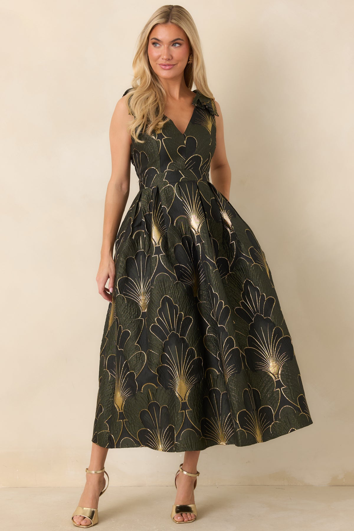 Olive jacquard dress featuring delicate ruffle shoulder straps and a fitted waist above a voluminous skirt.
