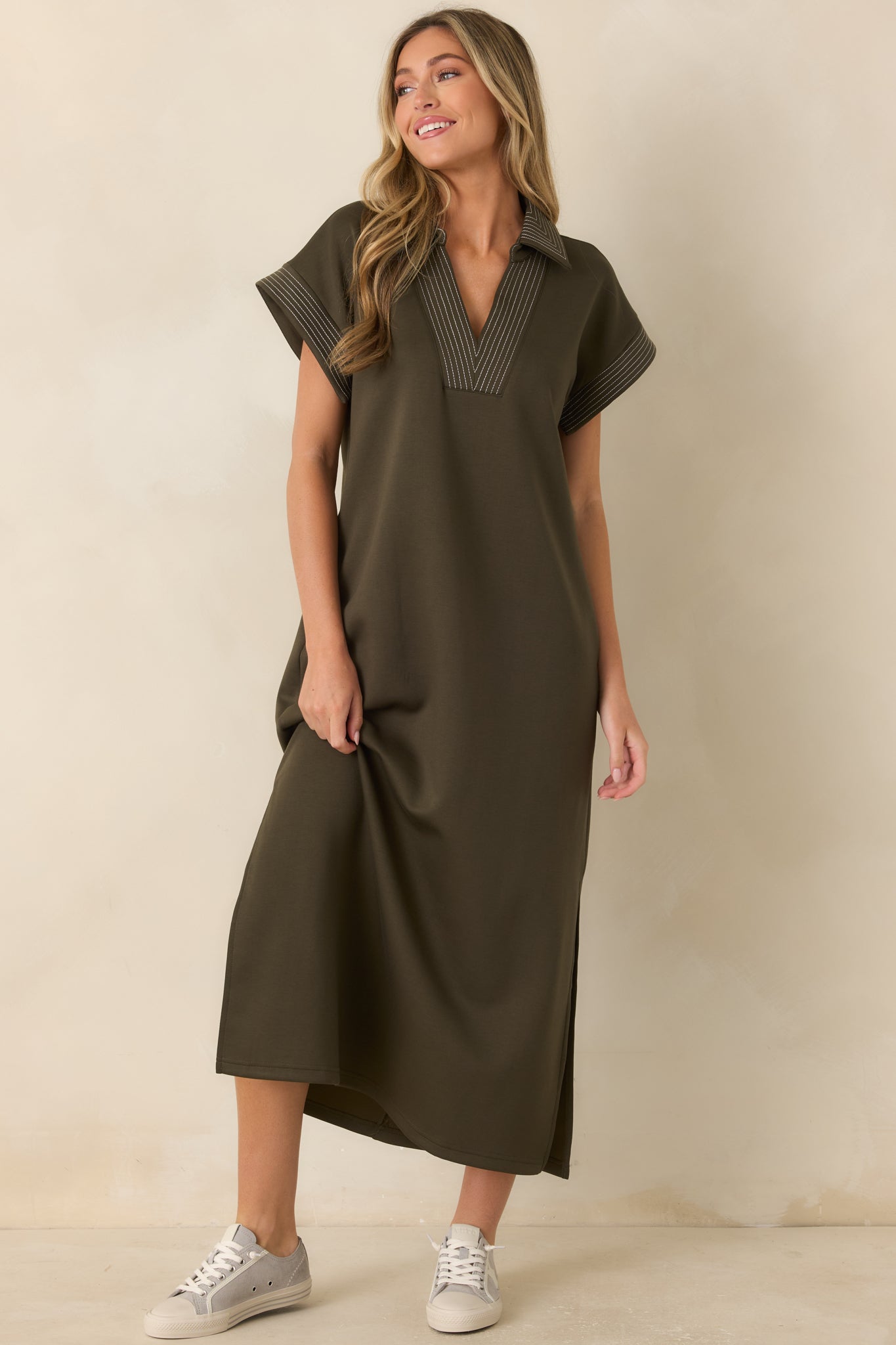 Olive knit maxi dress featuring a collared V-neckline, contrast pinstriped trim, side slits, and a relaxed silhouette with effortless style.