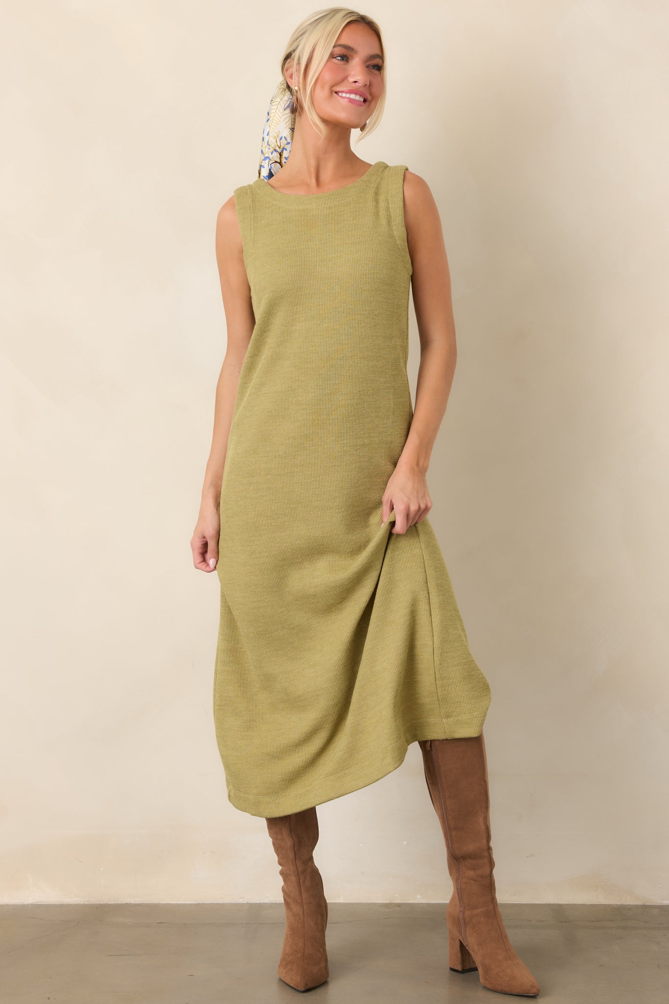 Olive green midi silhouette crafted from textured rib knit with a softly rounded neckline and clean finish.