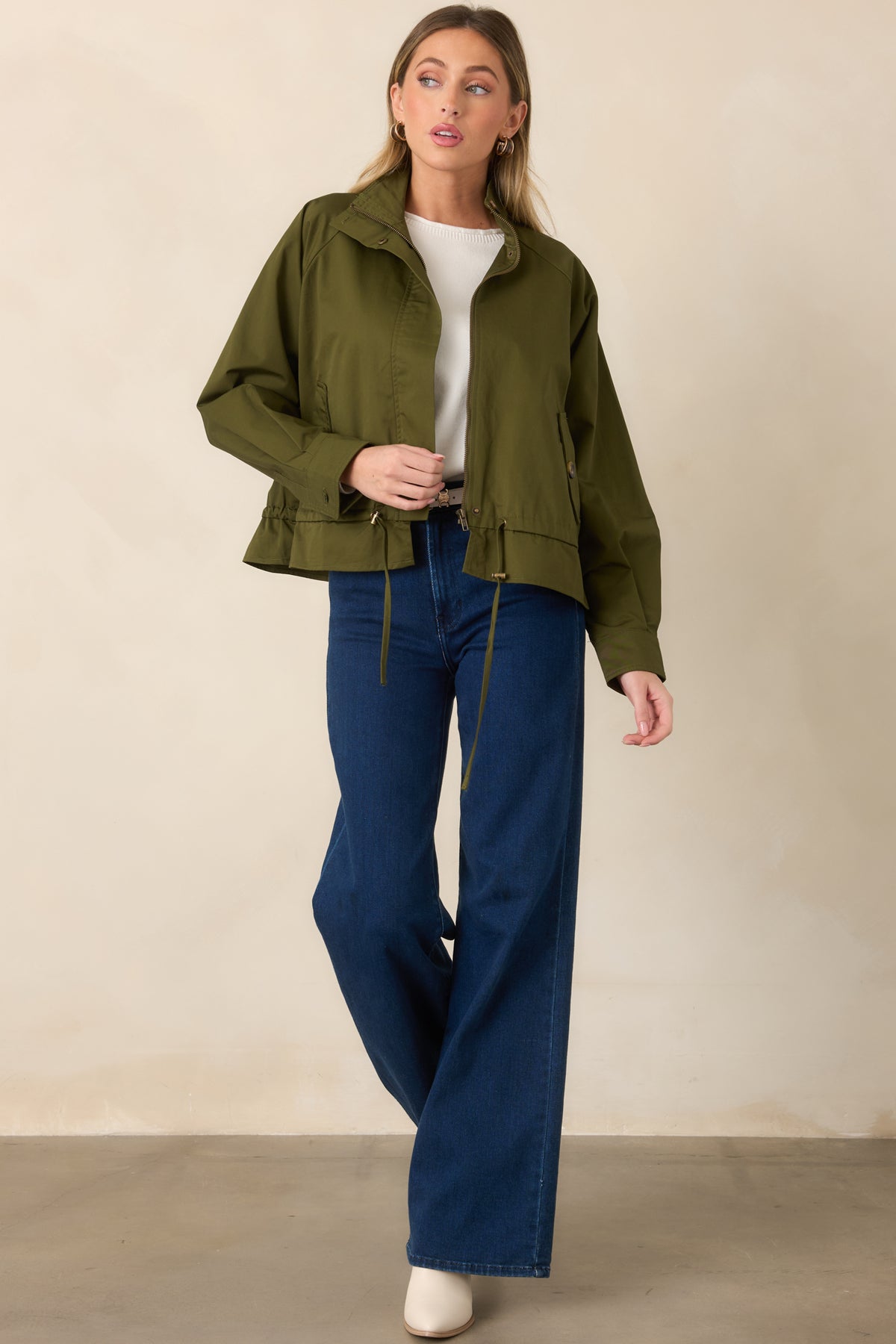 Versatile olive jacket with a polished zip front, snap detailing, and softly shaped waist.