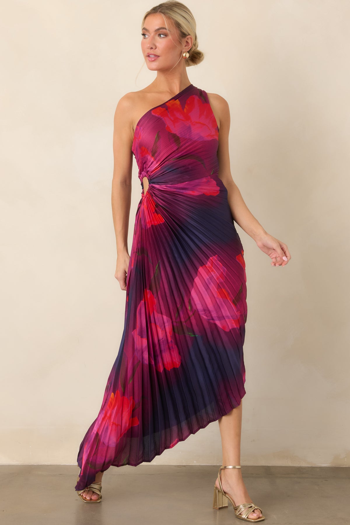 One-shoulder floral dress features a pleated construction, defined waist ruching, and an asymmetrical high-low hem.