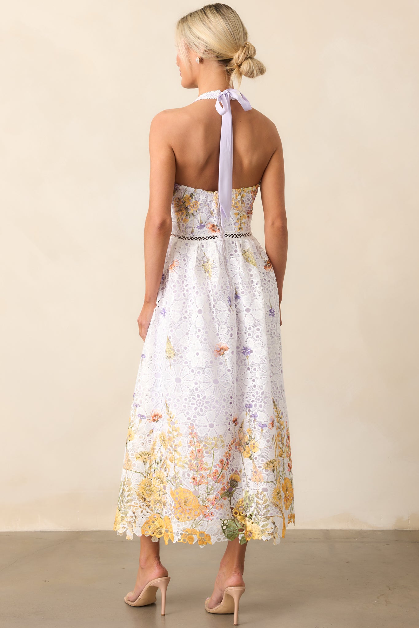 The open back of this midi dress is framed by a self-tie halter neckline, complete with a back zipper closure.