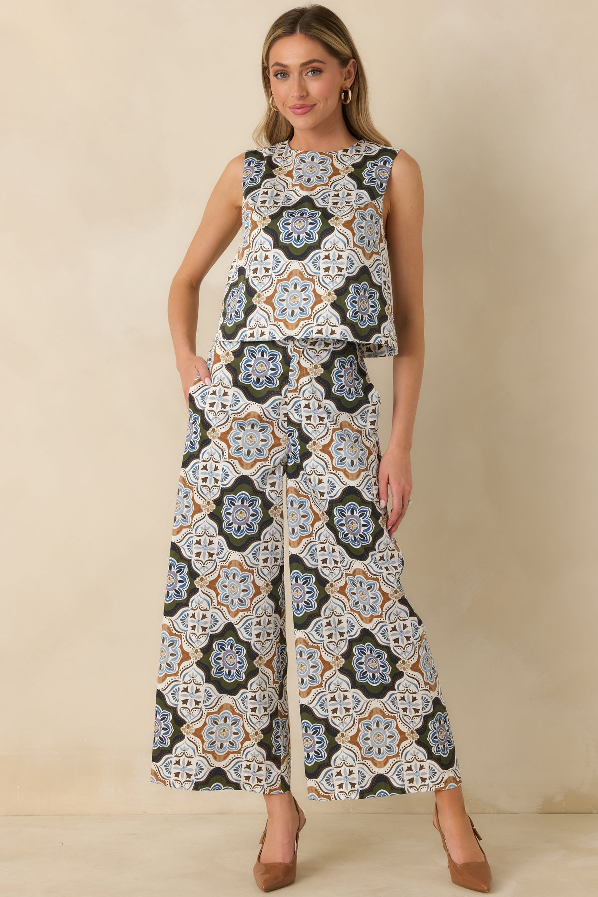 Ornate medallion print pants featuring a flattering high-rise waist, front button closure, and roomy side pockets.