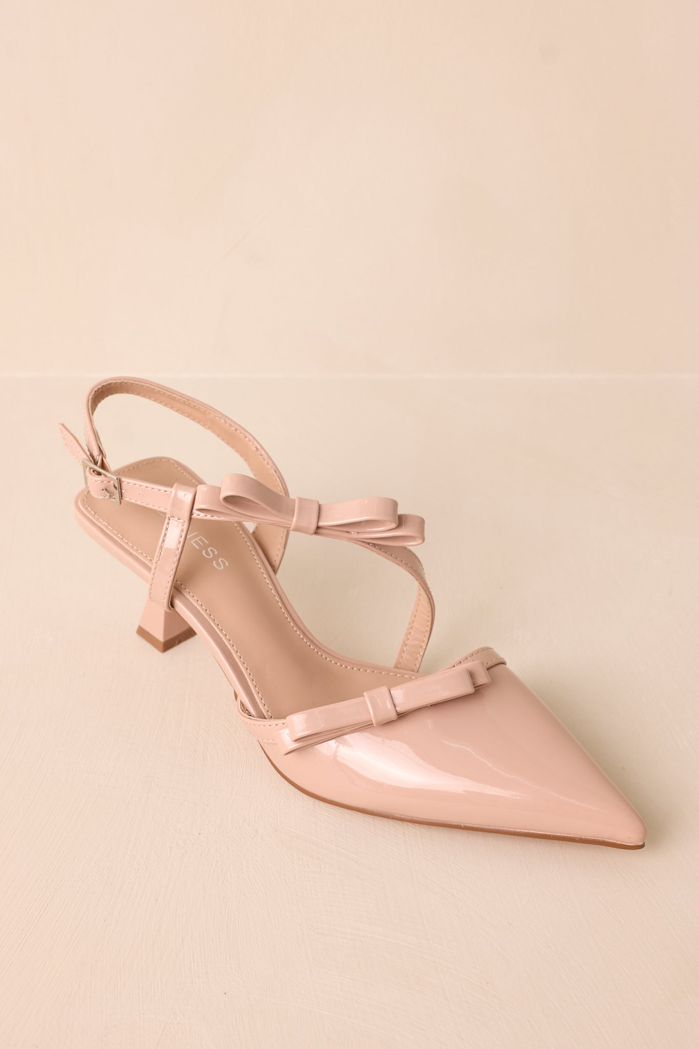 Overhead perspective displaying the bow details, foot strap, and structured design of the shoes.