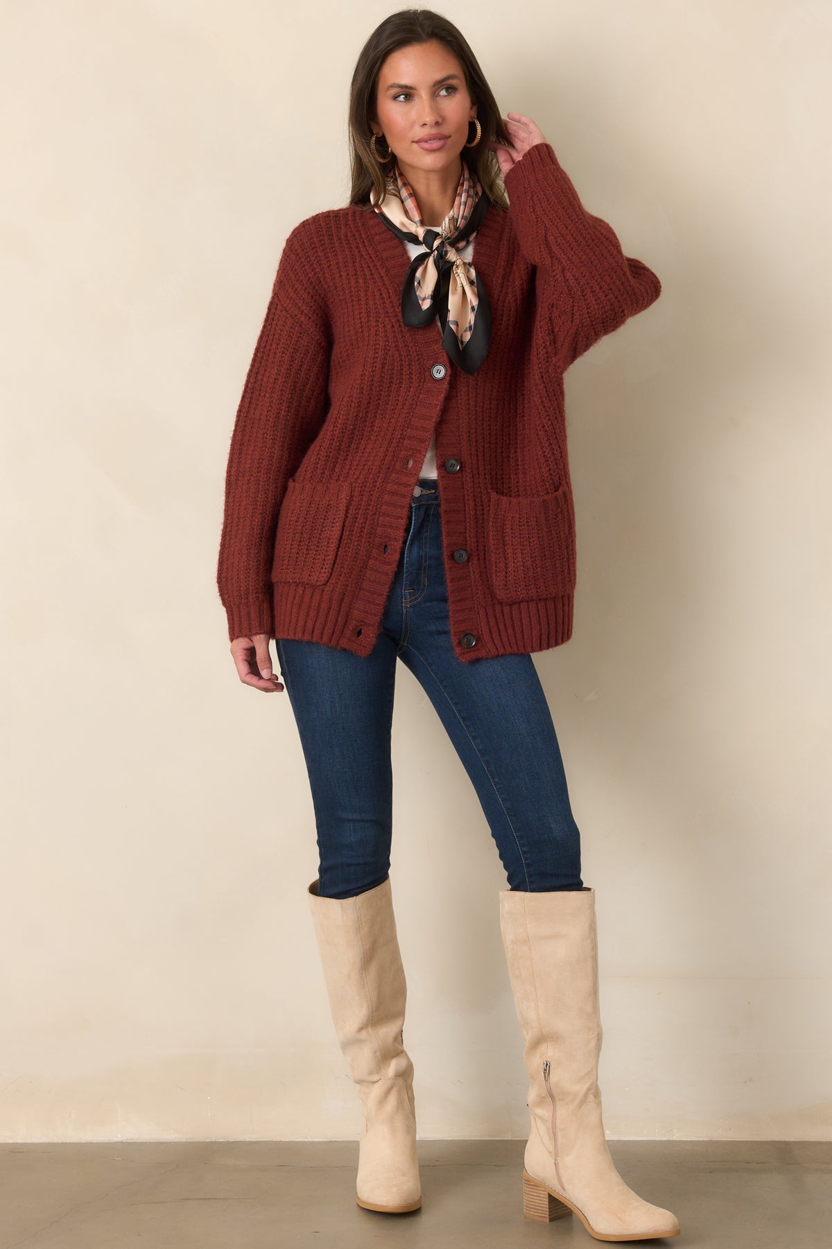 Oversized knit cardigan featuring a relaxed silhouette, V-neckline, dark buttons, and a straight hip-length hem.