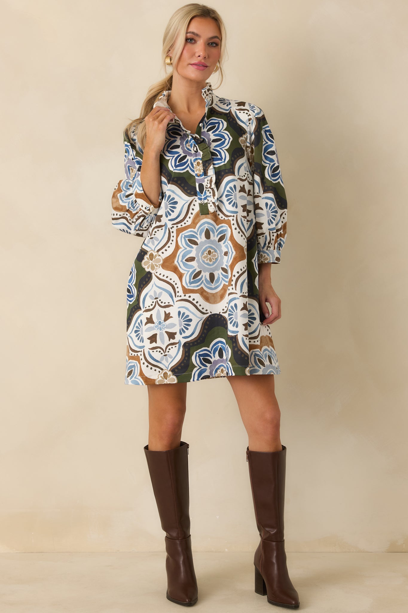 Oversized medallion mini dress featuring a ruffled stand collar, buttoned cuffs, and softly voluminous balloon sleeves.