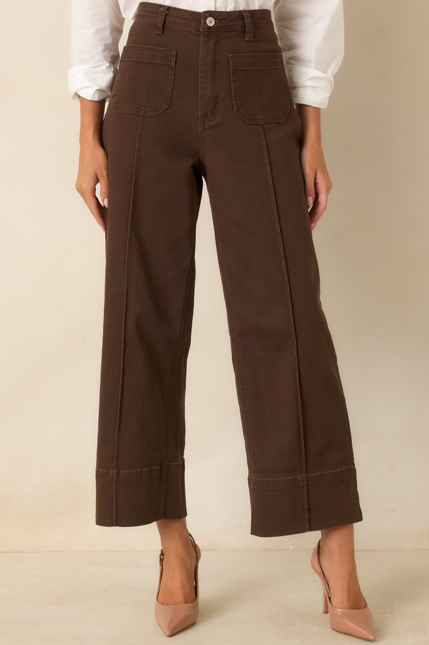 Detailed view of the oversized front patch pockets highlighting the utility-inspired design and rich brown fabric.