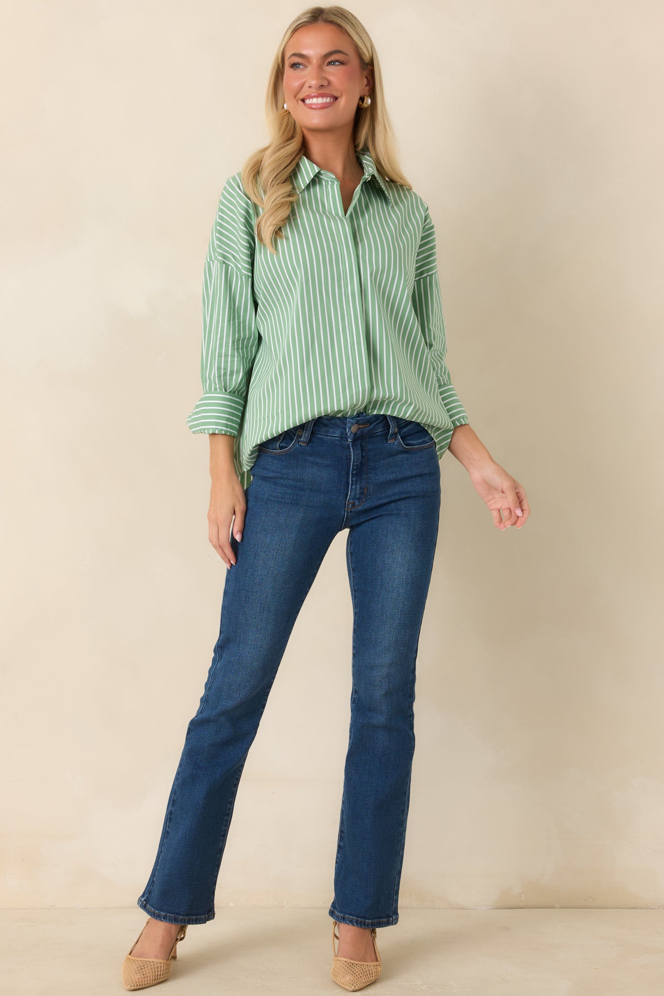 Oversized striped blouse with a classic collar, button-front closure, drop shoulders, and polished long sleeve design.
