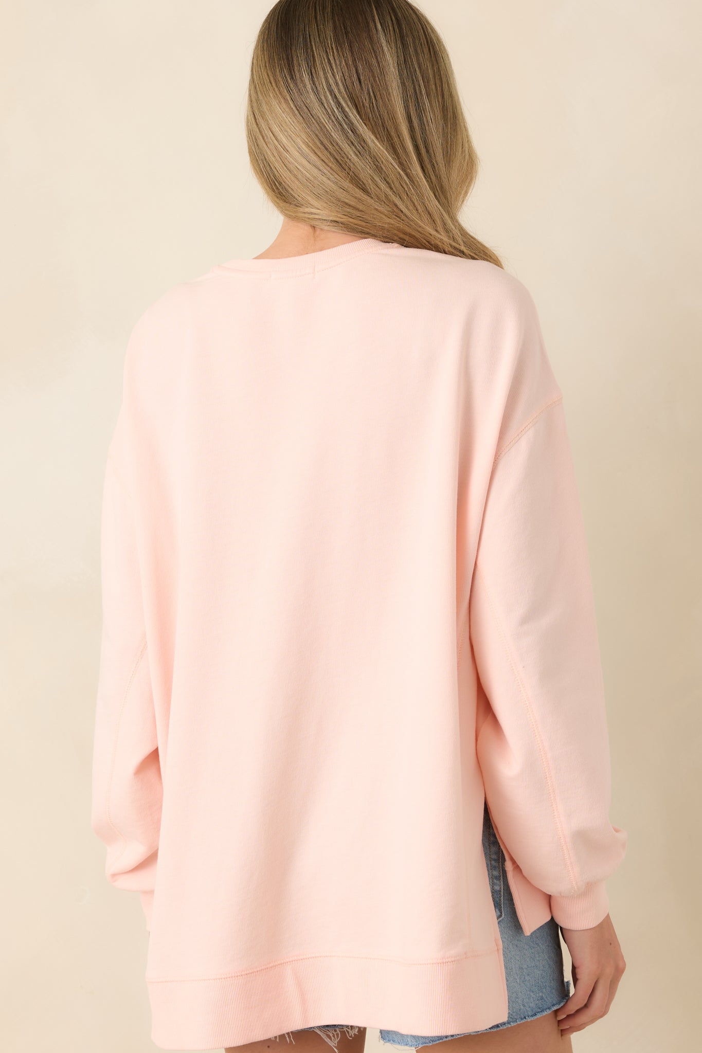 Oversized top rear view with relaxed drape, clean construction, and subtle structure.